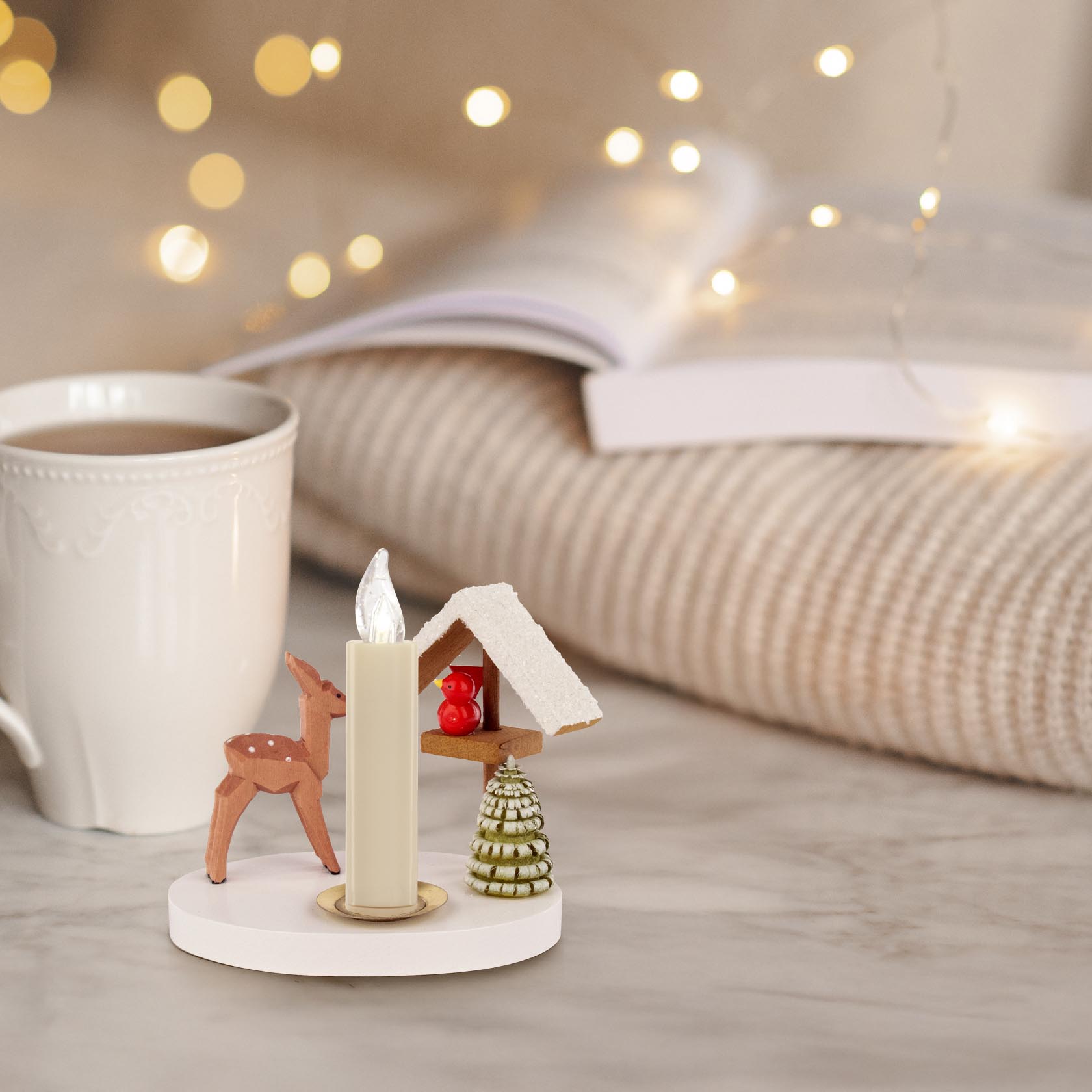 Candle holder with a birdhouse and a small deer; suitable for a 14mm diameter candle. Decorated with a miniature Christmas tree and red berries.