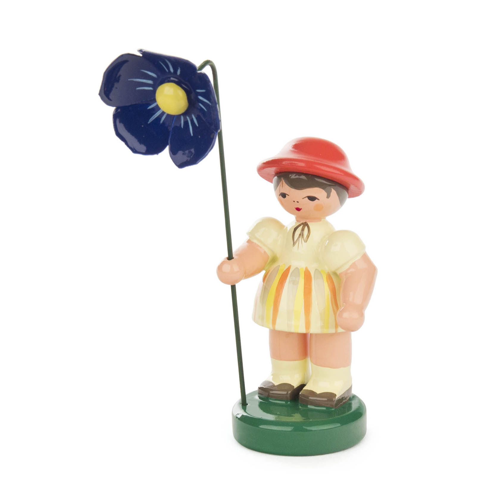 A wooden figure of a girl in a light yellow and orange striped dress and red hat, holding a blue flower on a green base. im Dregeno Online Shop günstig kaufen