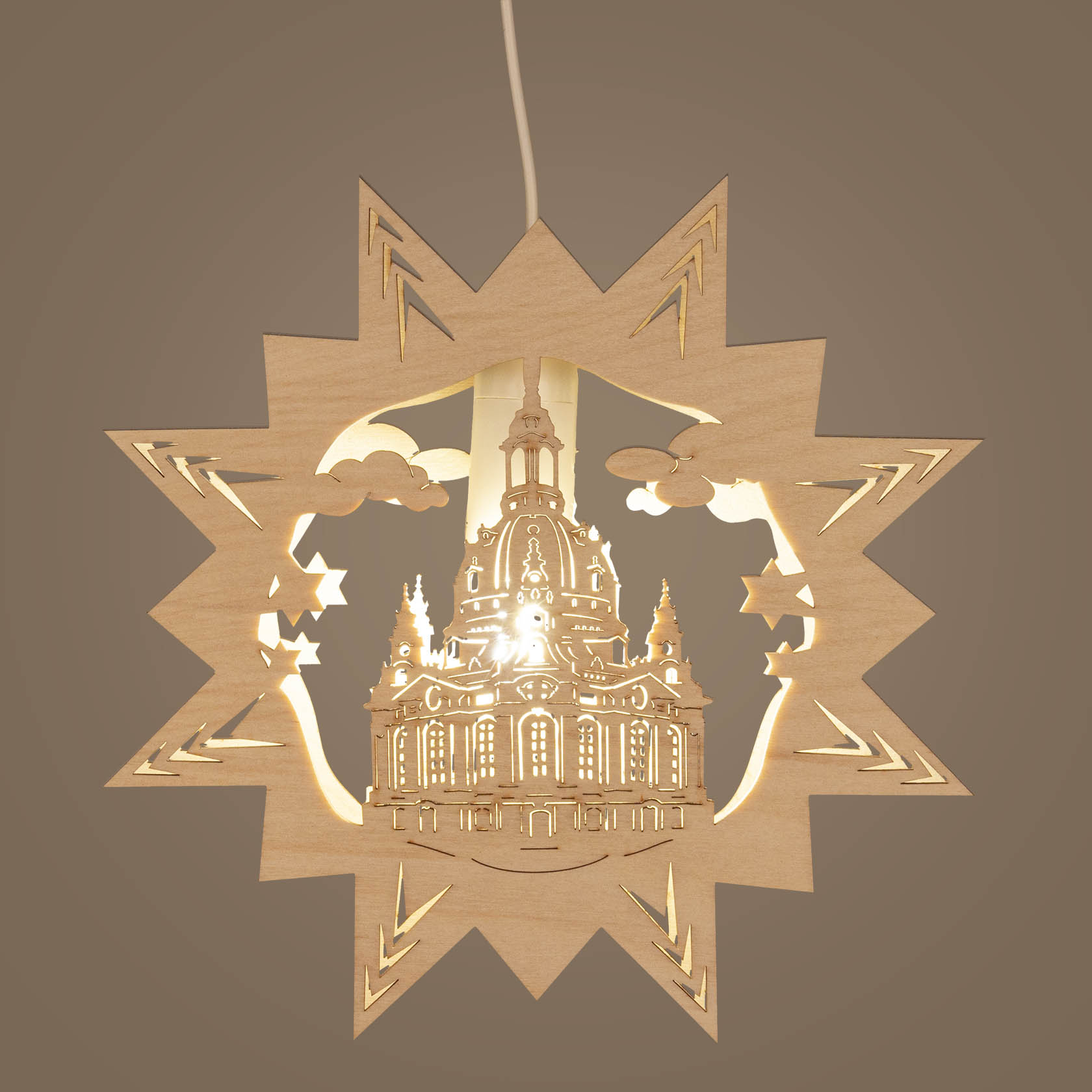Illuminated wooden silhouette of the Frauenkirche, Dresden, with an electric light inside, surrounded by star-shaped border.