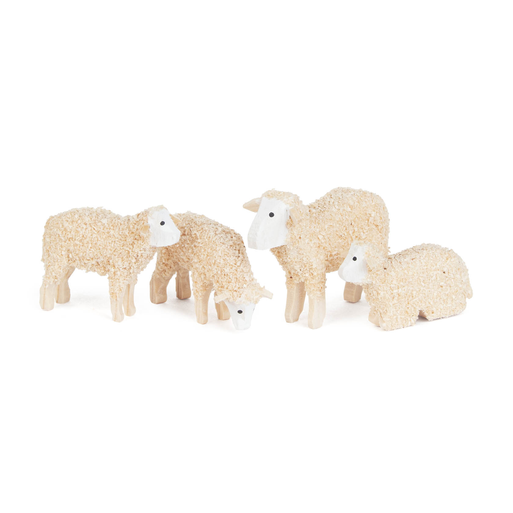 Four small, beige, textured sheep figurines standing and resting. The sheep have white faces and are positioned closely together. im Dregeno Online Shop günstig kaufen