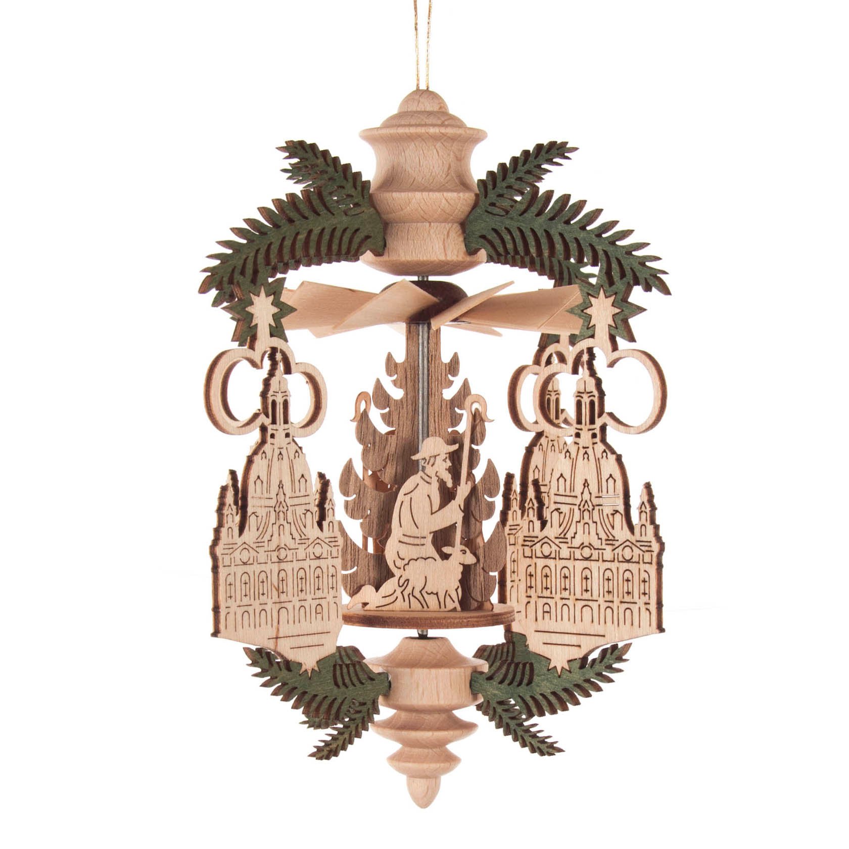 Wooden ornament depicting the Dresden Frauenkirche and a nativity scene, adorned with green leaves and designed to hang.