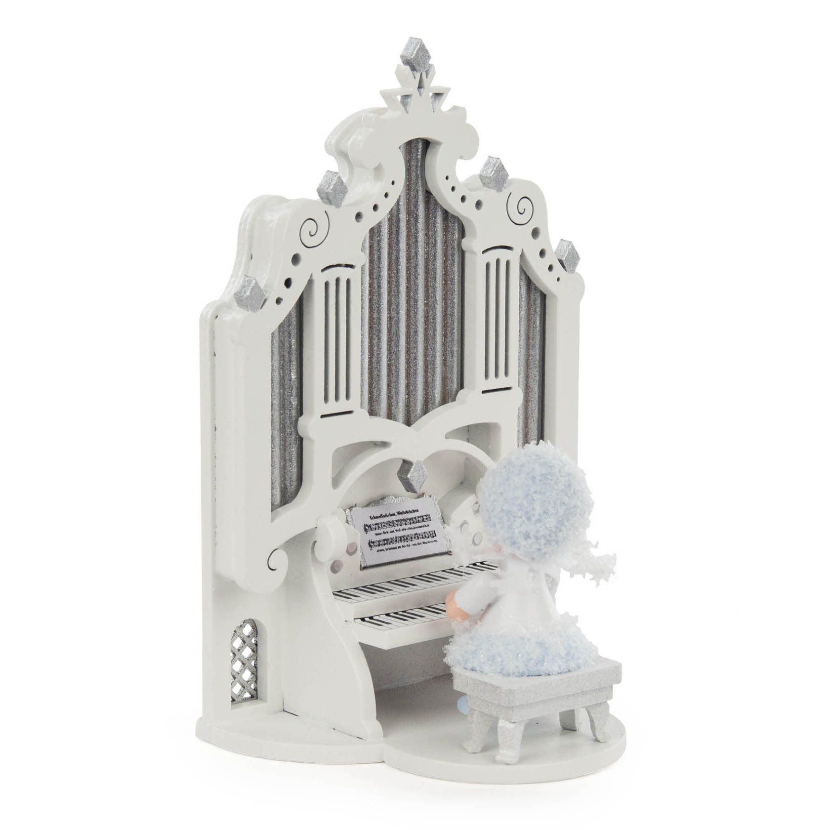 A decorative snowflake-themed figurine of a little angel playing a white and silver organ with intricate designs.
