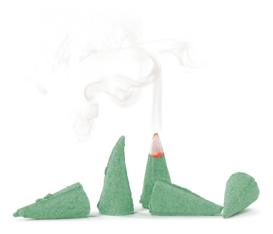 Several green incense cones with one lit, emitting smoke.