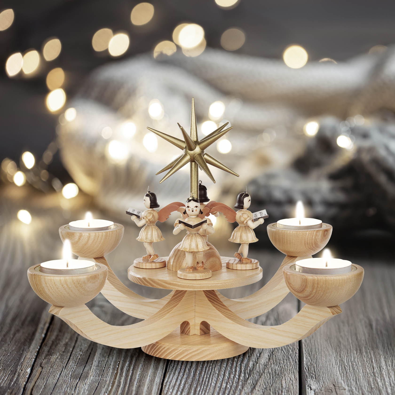 Wooden advent candelabra with 4 angel figurines holding song books, designed for tea lights, with a golden star on top.