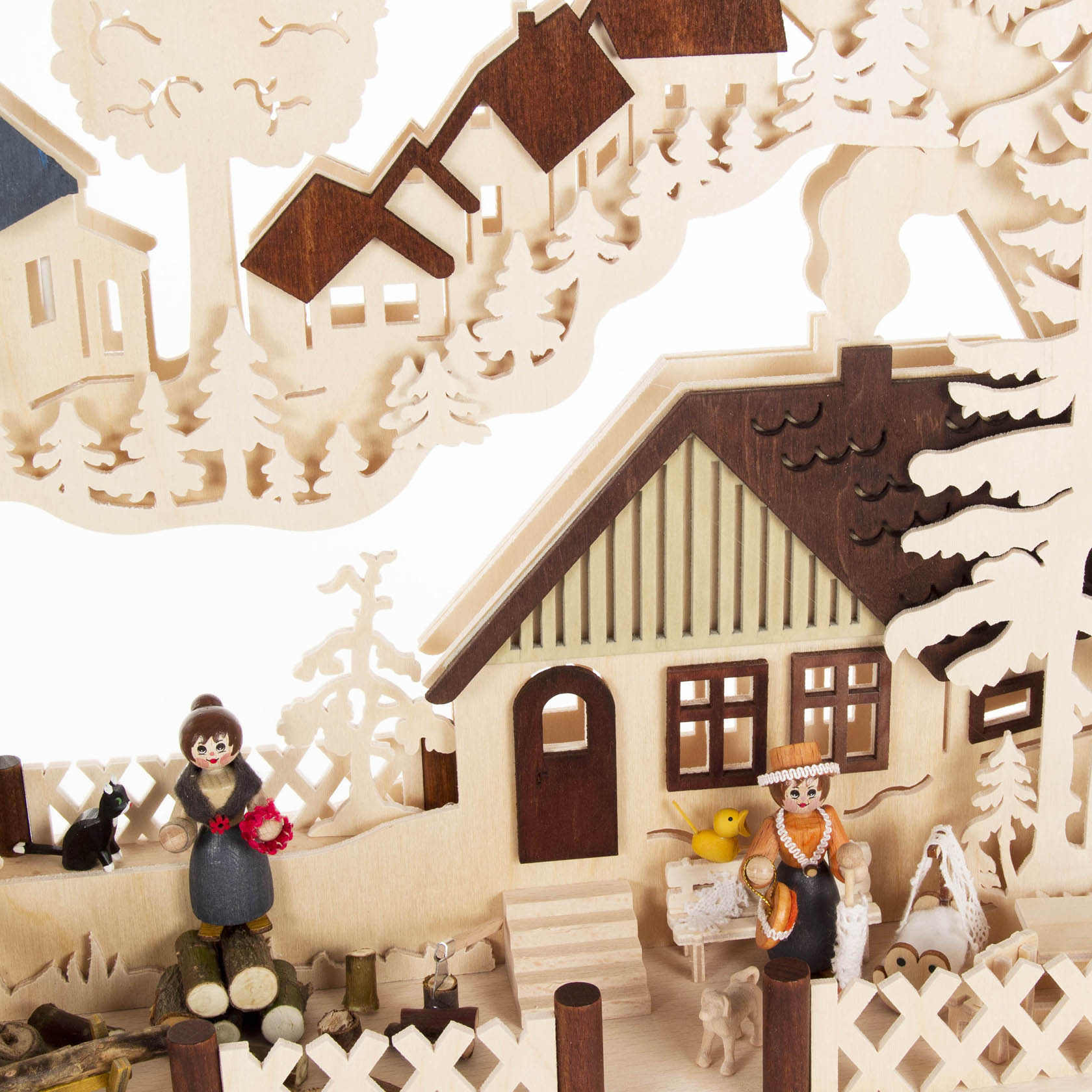 A large, electrically backlit Schwibbogen depicting an idyllic village scene with a woman holding flowers, a boy, a dog, a black cat, a chicken, and a baby stroller.