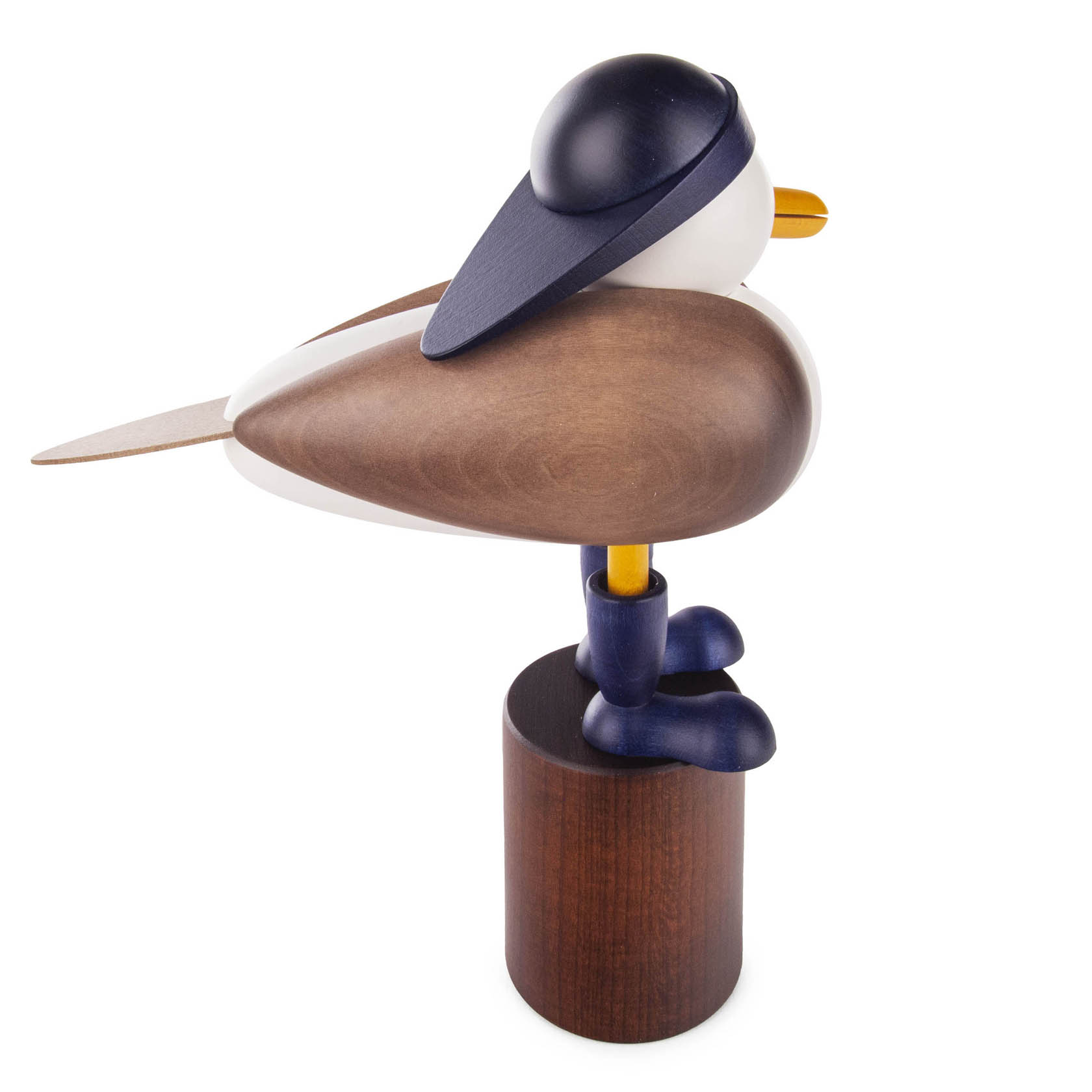 Wooden figurine of a seagull wearing a navy blue rain hat, standing on a brown cylindrical pedestal.
