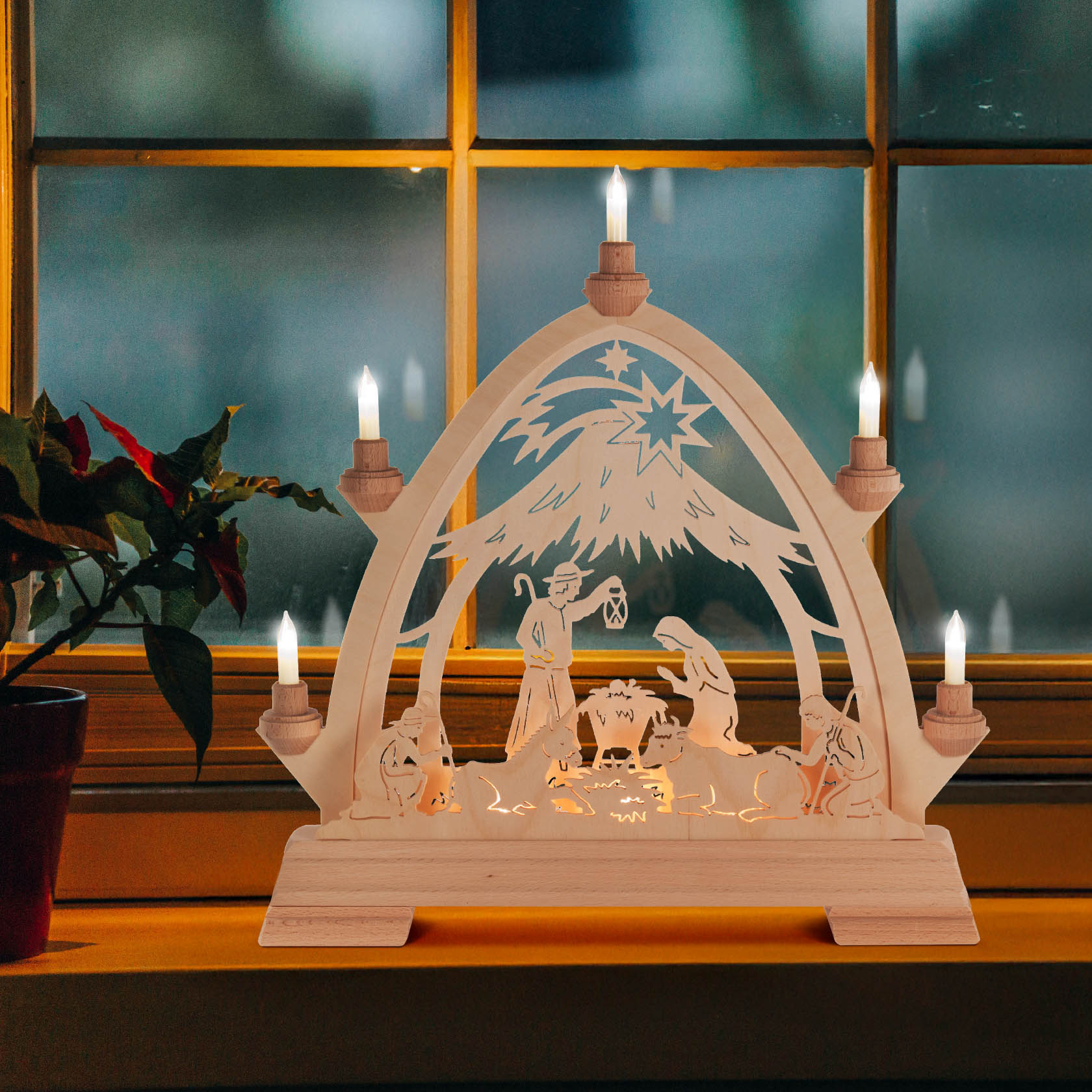 A wooden arched nativity scene with electric candles, depicting the birth of Christ. The scene includes Joseph, Mary, the baby Jesus in a manger, and a star.