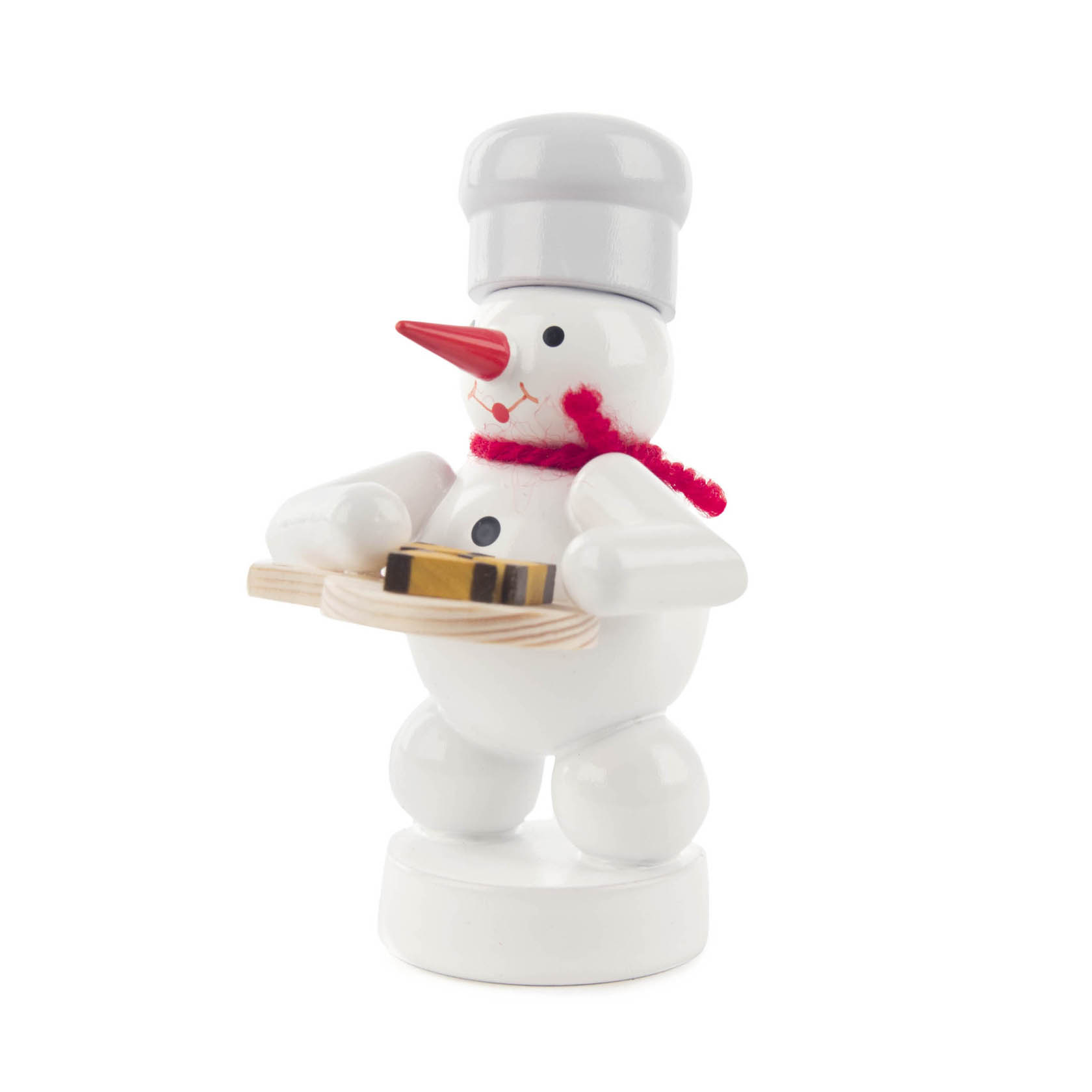 A small snowman figure dressed as a baker, holding a tray with nut wedges, and wearing a chef's hat and red scarf. im Dregeno Online Shop günstig kaufen