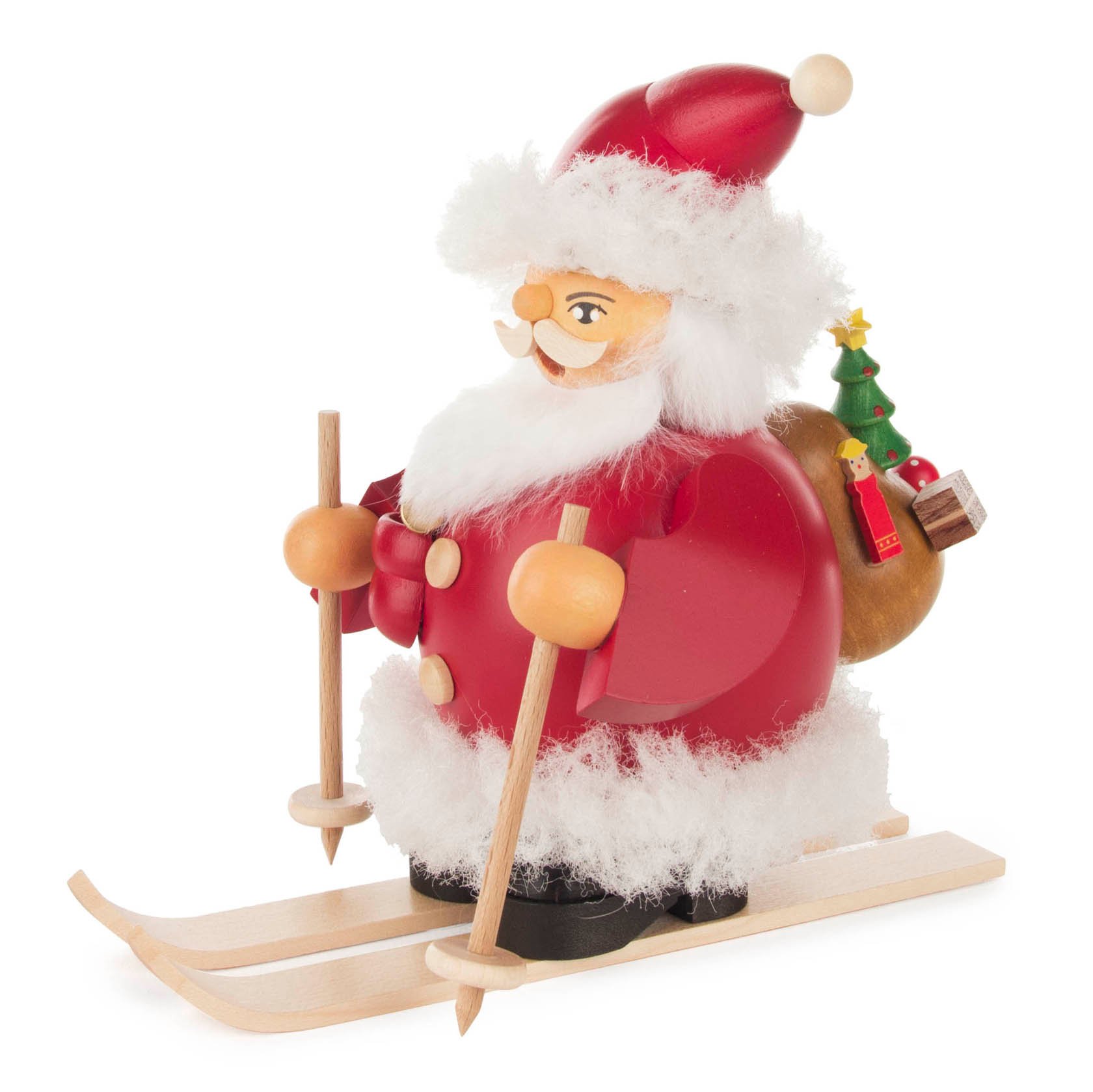 A wooden smoking figure of Santa Claus wearing red and white, holding ski poles, standing on skis with a sack of gifts on his back.