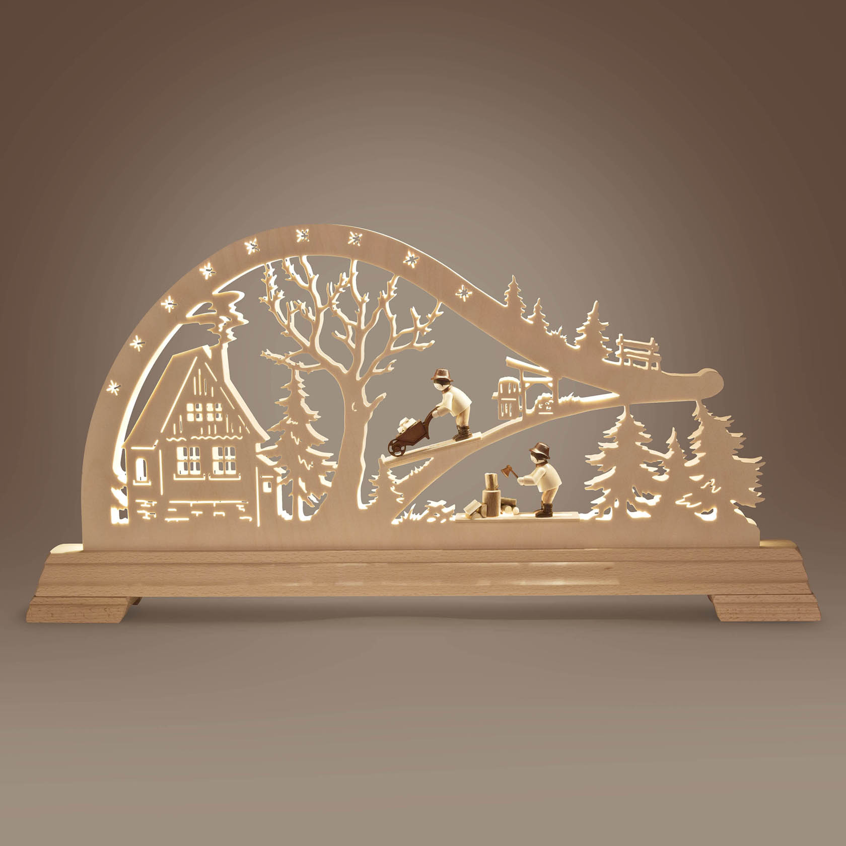 Wooden arch with LED lights depicting a forest scene with a cabin and two woodworkers. Trees and stars are intricately carved.