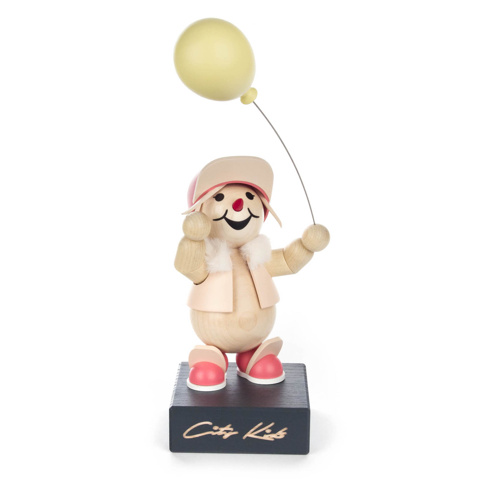 Wooden figure of a happy child holding a yellow balloon, wearing a pink cap, jacket, and shoes, standing on a black base labeled 'City Kids'.