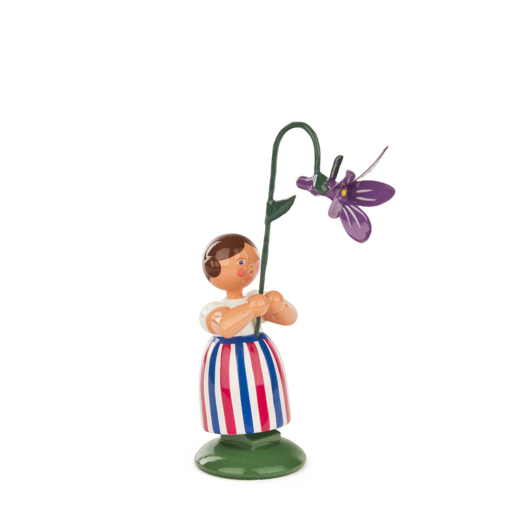 A wooden figurine of a girl holding a large violet flower. The girl is wearing a striped dress with red, white, and blue vertical lines.