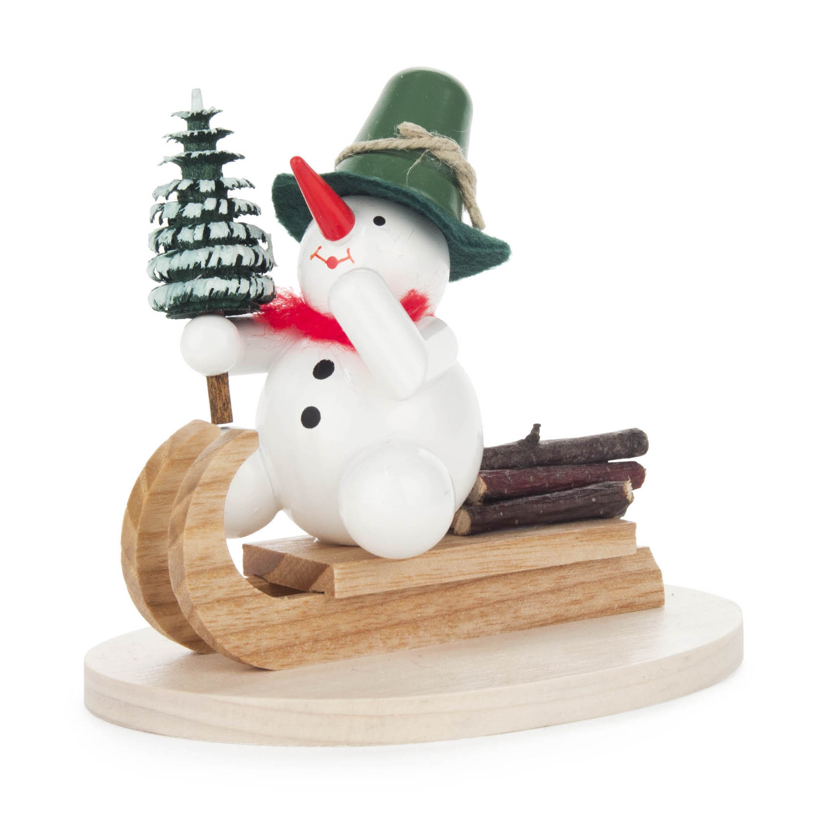 A small snowman figurine with a green hat and red scarf is sitting on a sled, holding a miniature green Christmas tree. im Dregeno Online Shop günstig kaufen