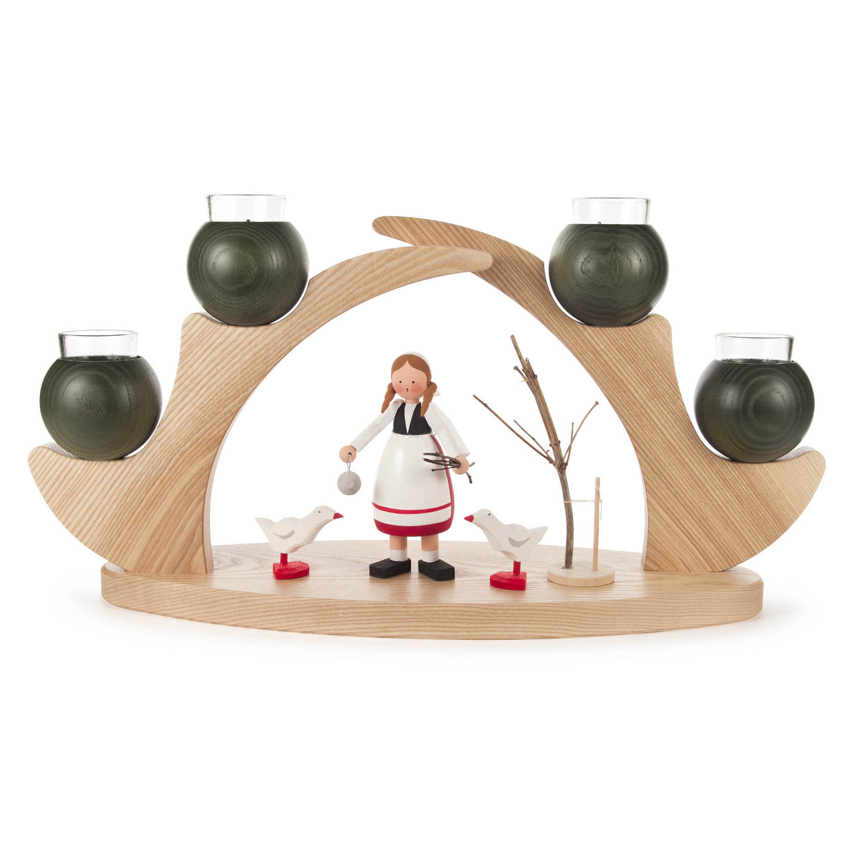 A wooden candle holder with four green spherical candle cups. In the center, a figurine of a woman in an apron feeding two white birds.