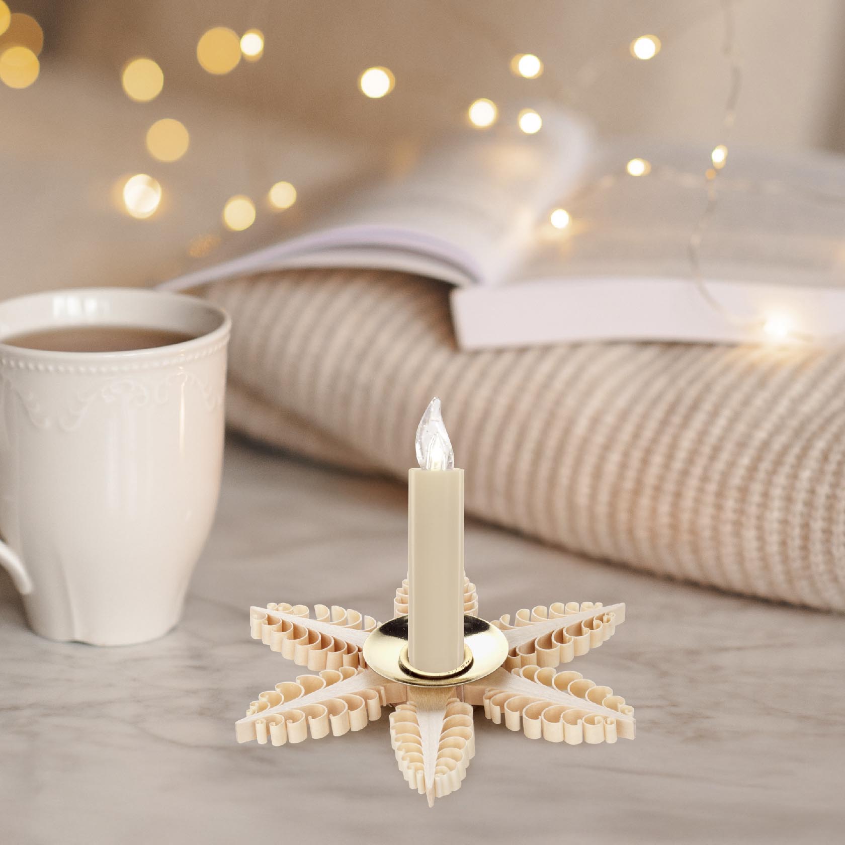 A decorative candle holder shaped like a star with intricate wooden details, holding a white candle with a small flame.