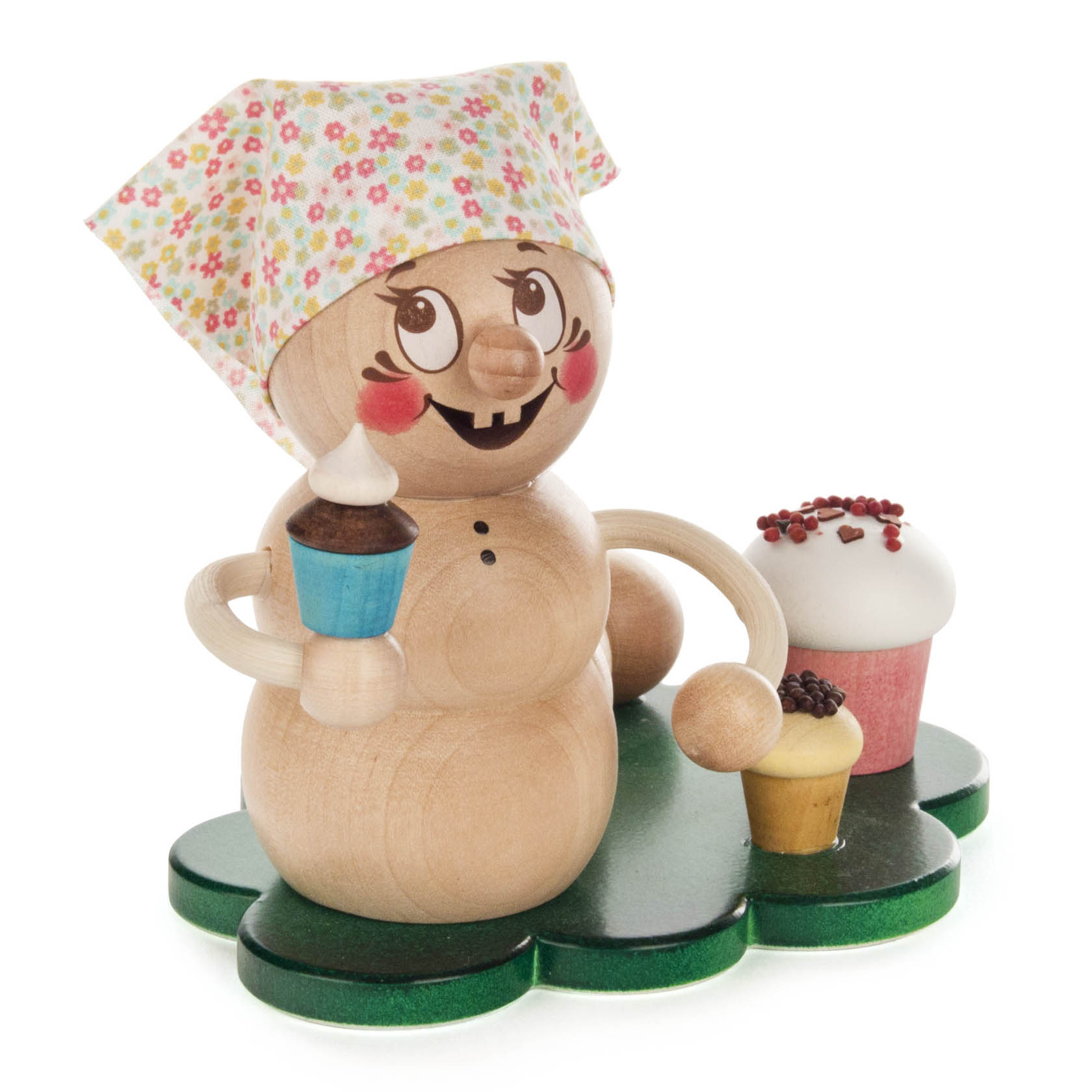Holzfigur eines lächelnden Bechers mit Schürze und Häubchen, hält einen blauen Muffin, zwei weitere Muffins auf dem Sockel.