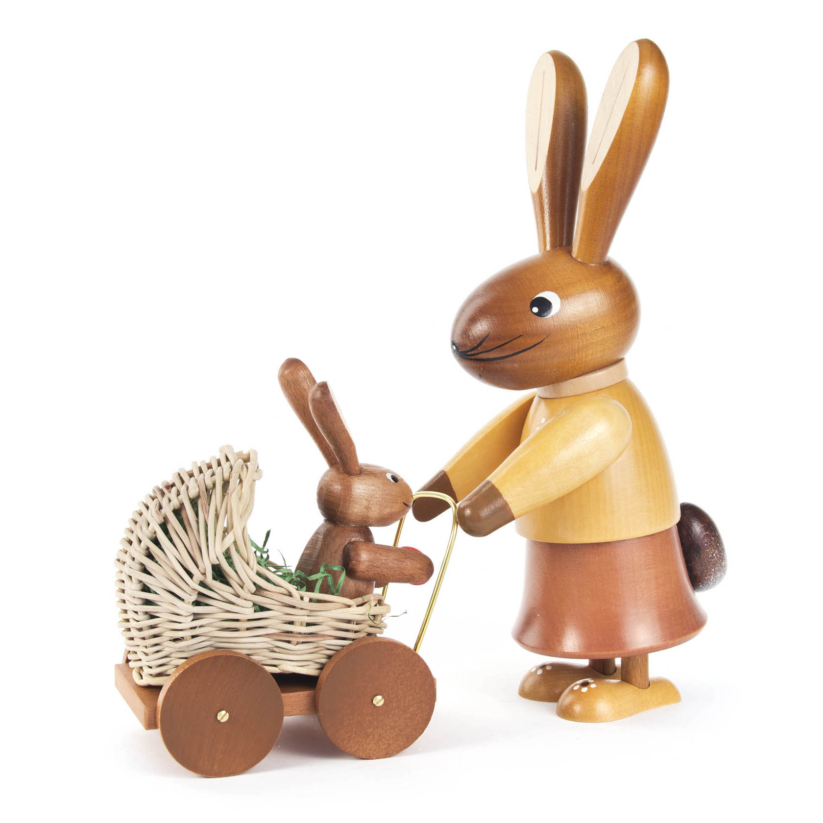 Wooden figure of a mother rabbit wearing a skirt, pushing a wicker stroller with a baby bunny in it, both crafted in a natural wood finish. im Dregeno Online Shop günstig kaufen