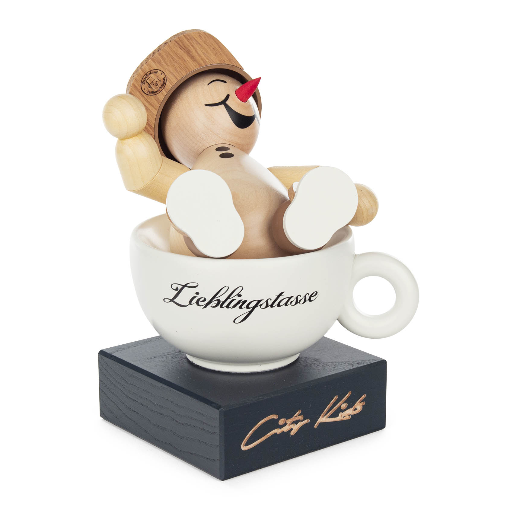 A wooden figure of a snowman with a bucket hat, red nose, and headphones, sitting in a cup labeled 'Lieblingstasse' on a wooden base.
