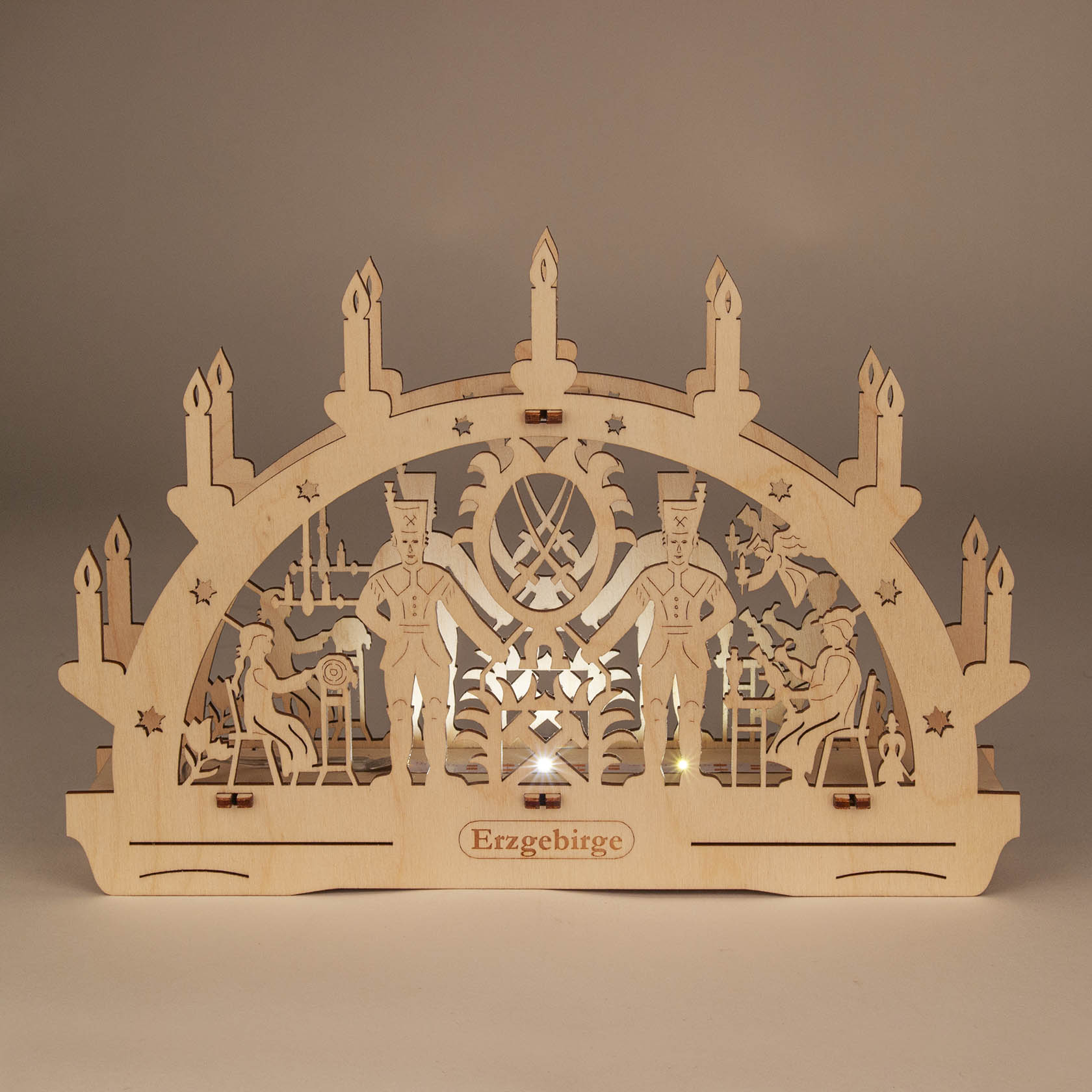 Wooden German Schwibbogen arch with LED lights, depicting miners and traditional Erzgebirge scene. Seven candles crown the arch.