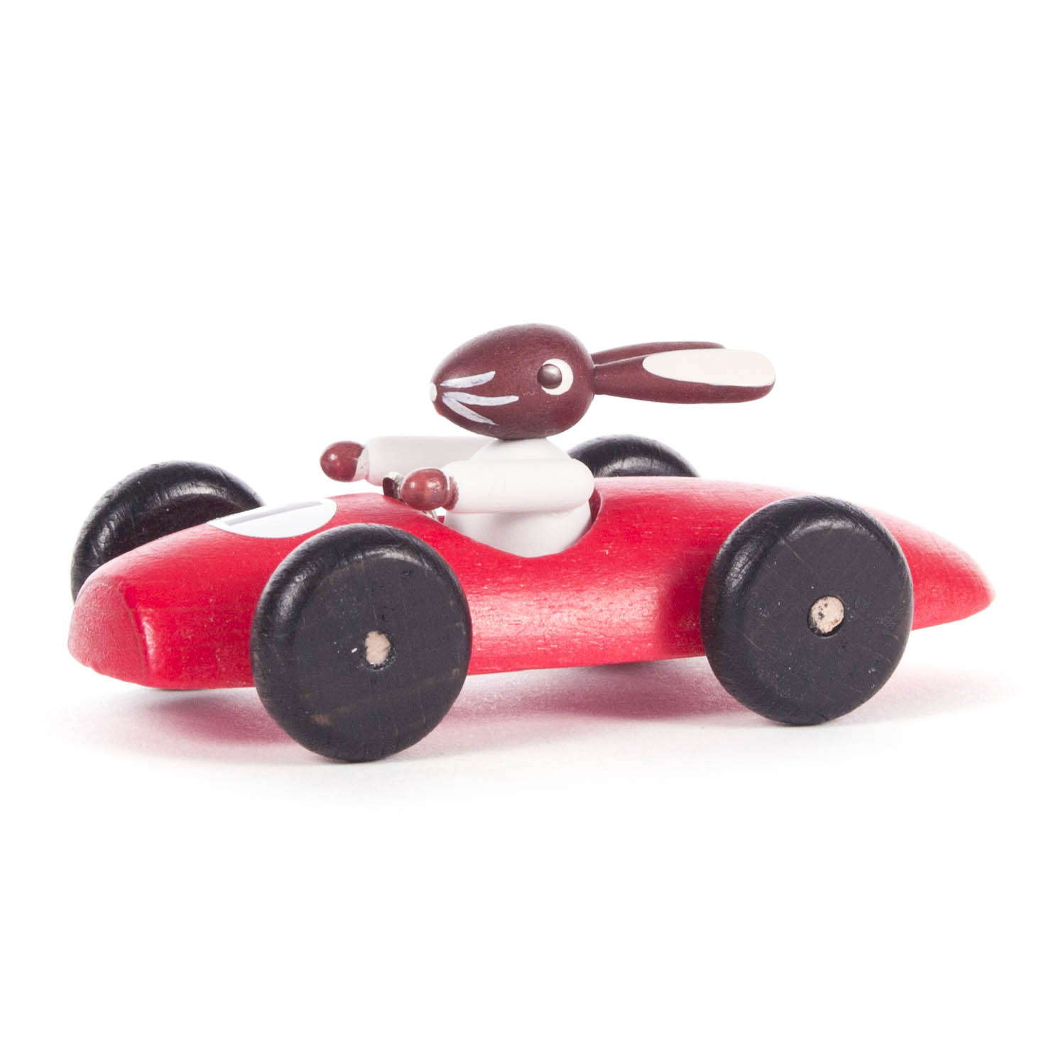 A small, red wooden race car toy with a brown bunny as the driver, featuring four black wheels. im Dregeno Online Shop günstig kaufen