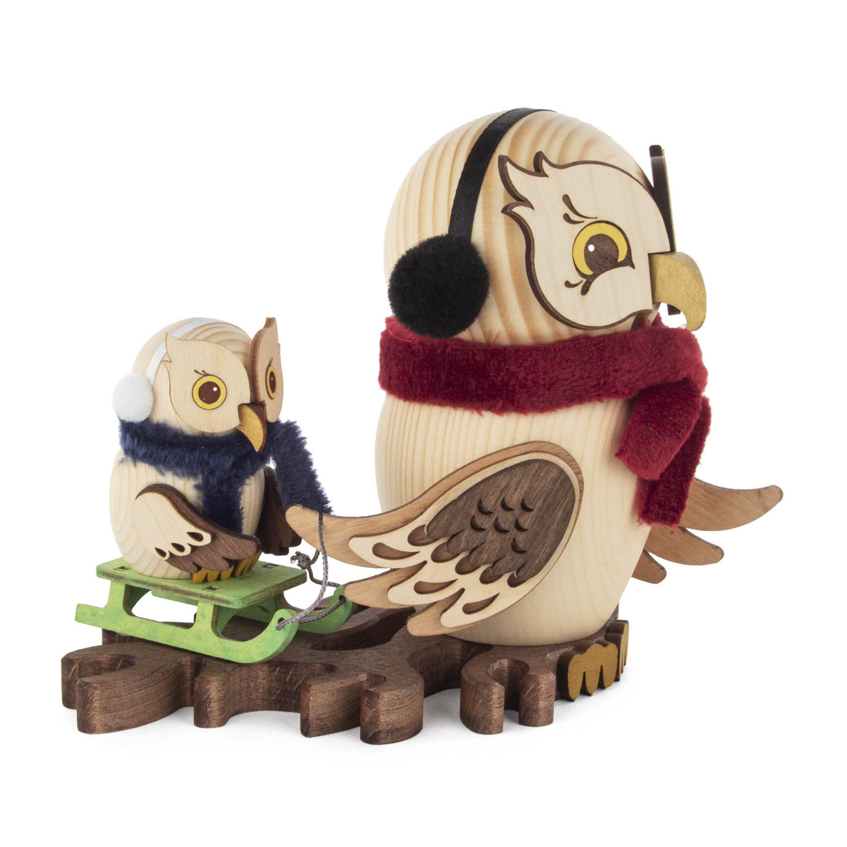 A wooden incense smoker owl wearing earmuffs and a red scarf, pulling a smaller owl on a green sled, both are crafted in detail.