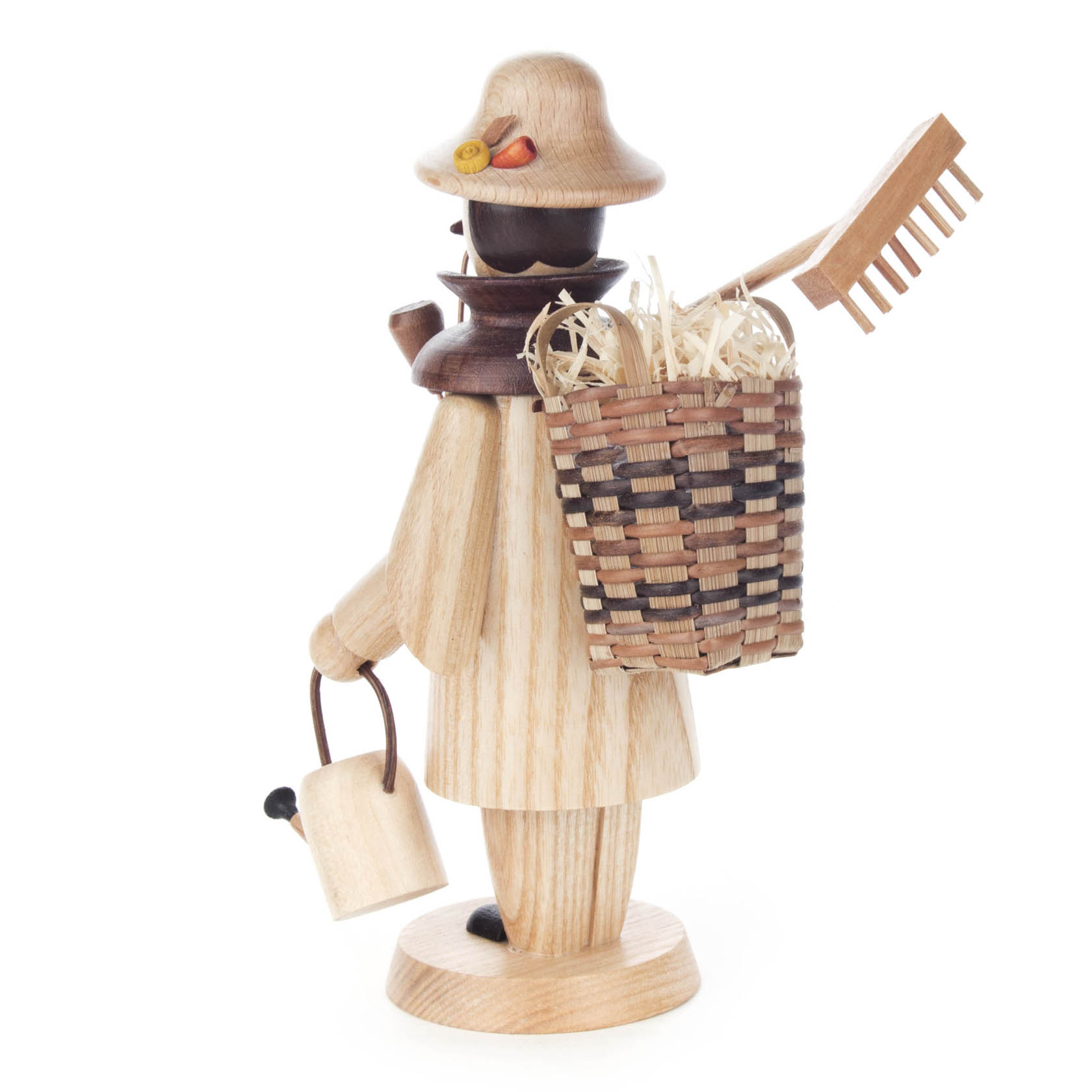 A wooden incense smoker figurine of a gardener with a hat, holding a watering can and a basket filled with straw and a rake on the back.