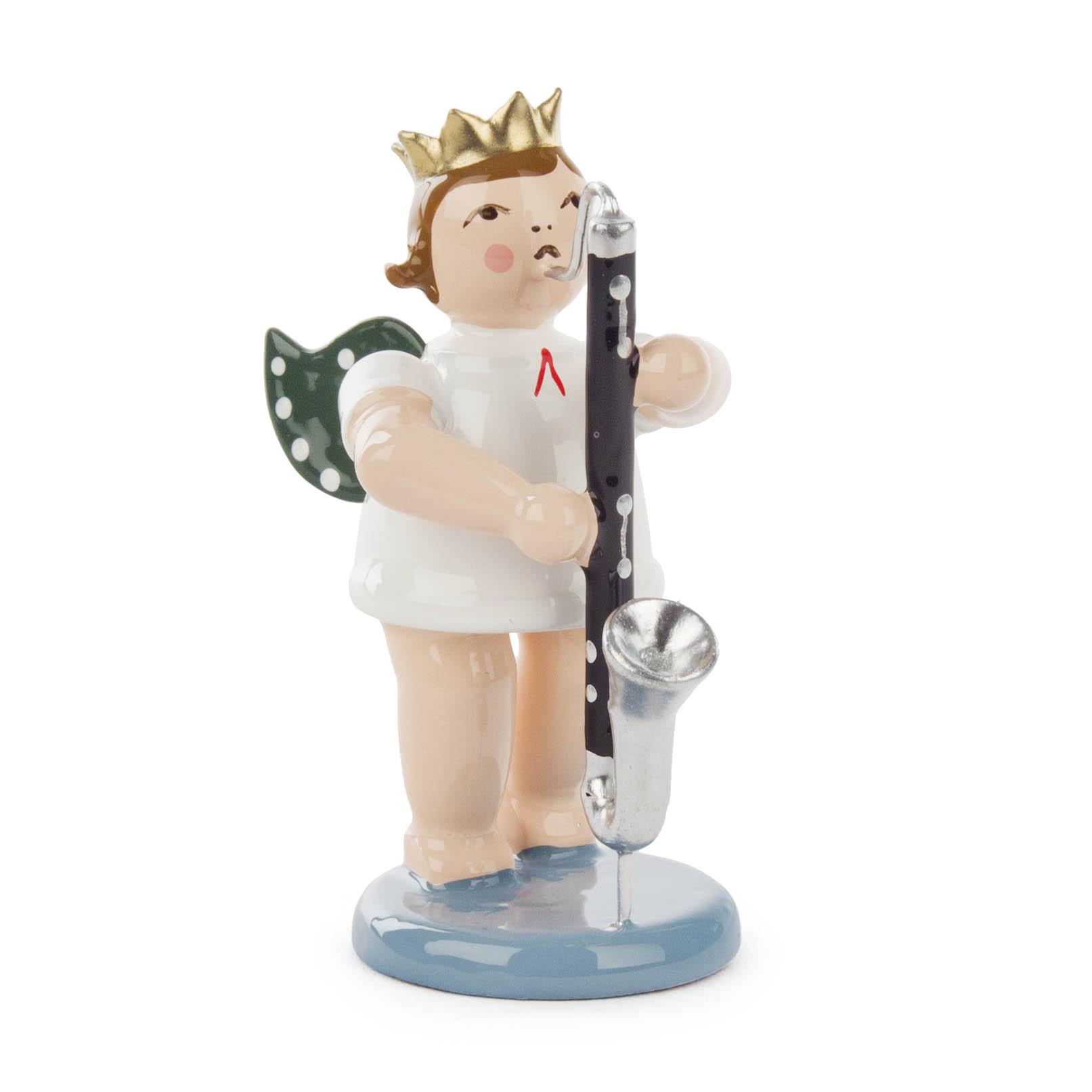 A porcelain figurine of an angel with a golden crown, green wings with white dots, and holding a bass clarinet, standing on a blue base.