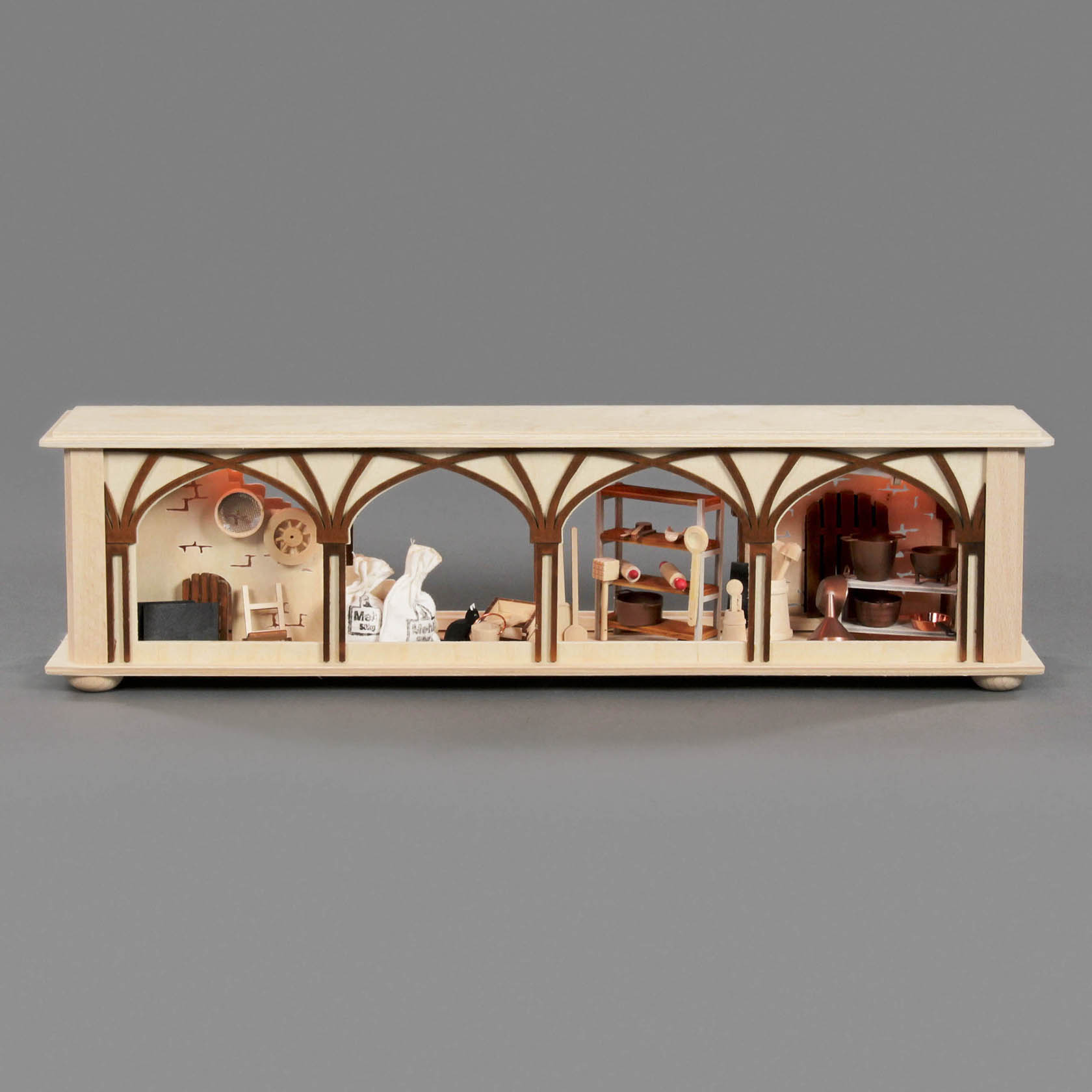 A small wooden universal base with three illuminated sections, each depicting miniature scenes of a flour chamber with tiny bags and tools.
