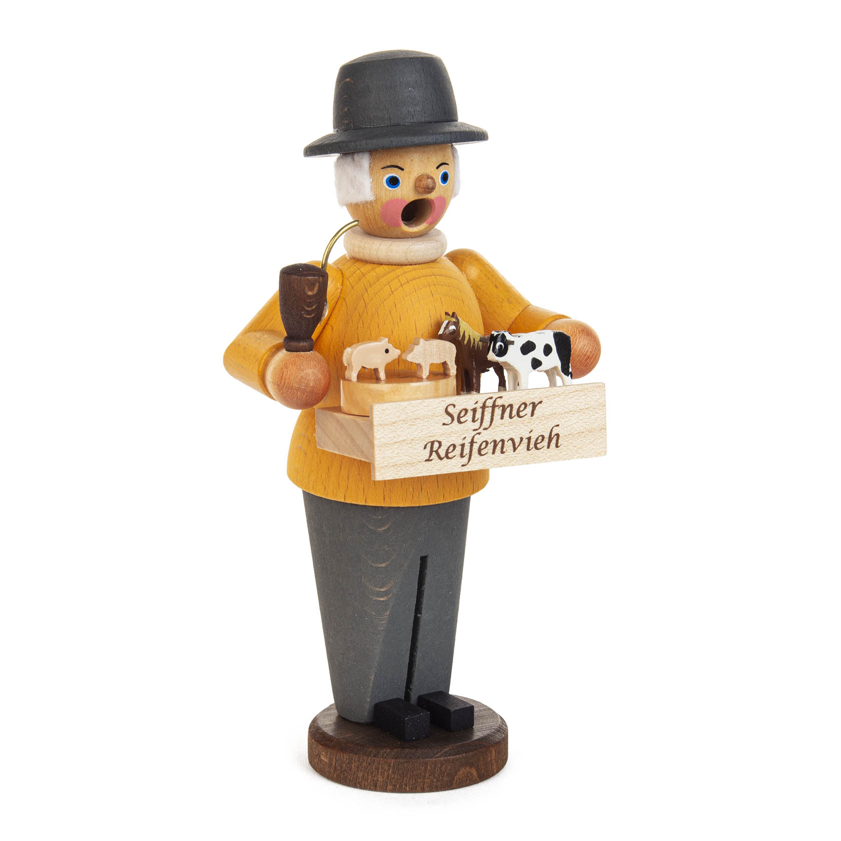 A miniature wooden smoker figurine with a traditional hat, holding a box labeled 'Seiffener Reifenvieh' containing small carved wooden animals.