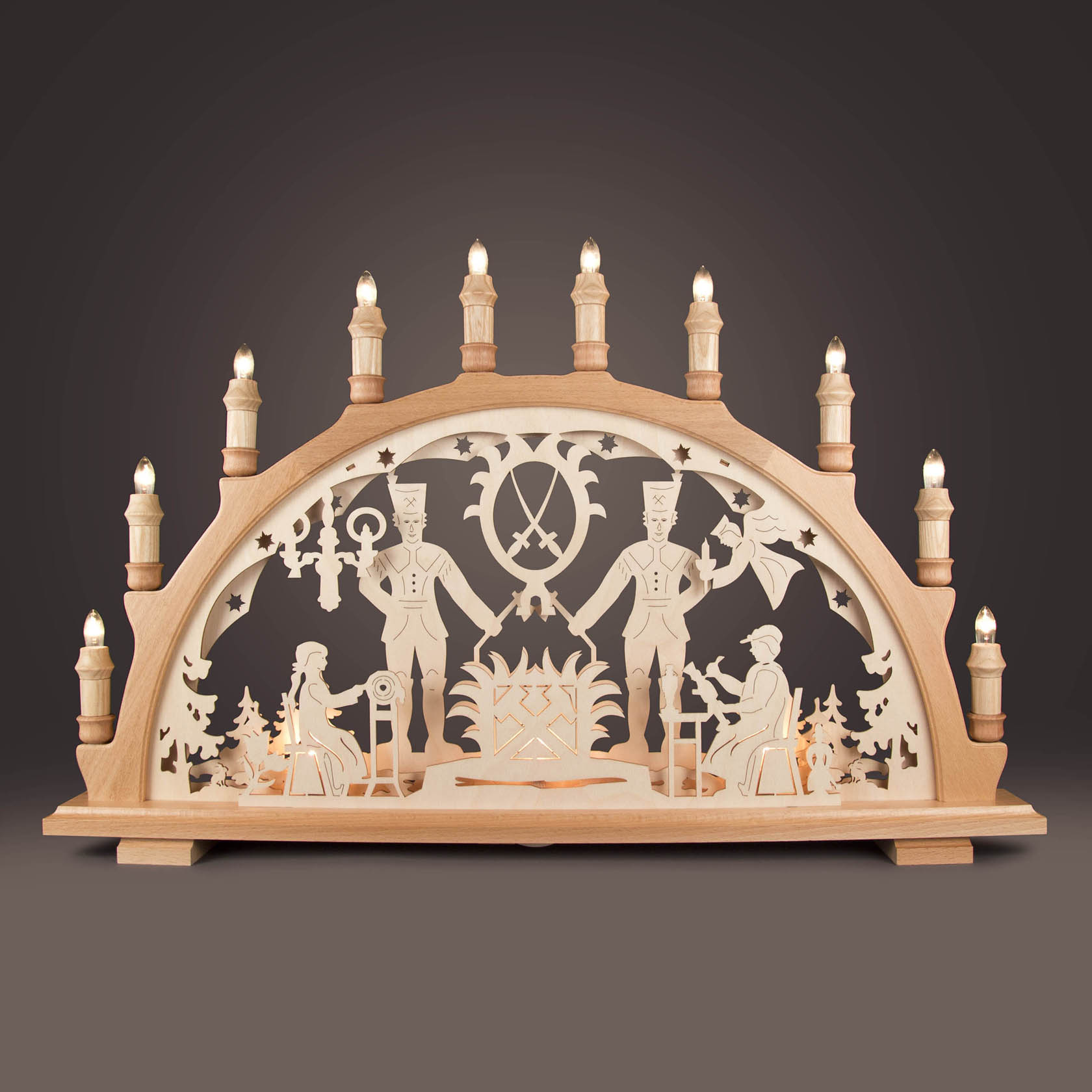 Wooden arch with LED lights depicting two miners in traditional attire and a pithead stock. The archway features intricate carvings and illuminated candle-like bulbs.