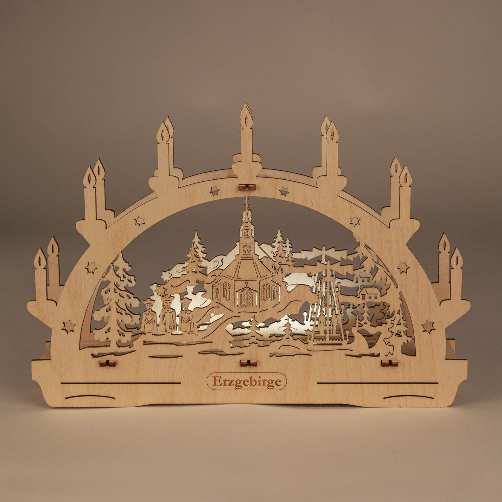 A wooden arch-shaped candle holder with LED lights, featuring a detailed carving of the Seiffen Church surrounded by trees and settings, without batteries.