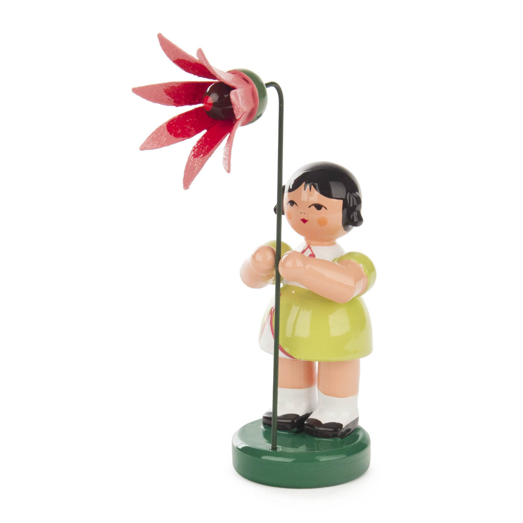 A wooden figurine of a girl in a light green dress holding a large coral-colored flower, standing on a green base. im Dregeno Online Shop günstig kaufen