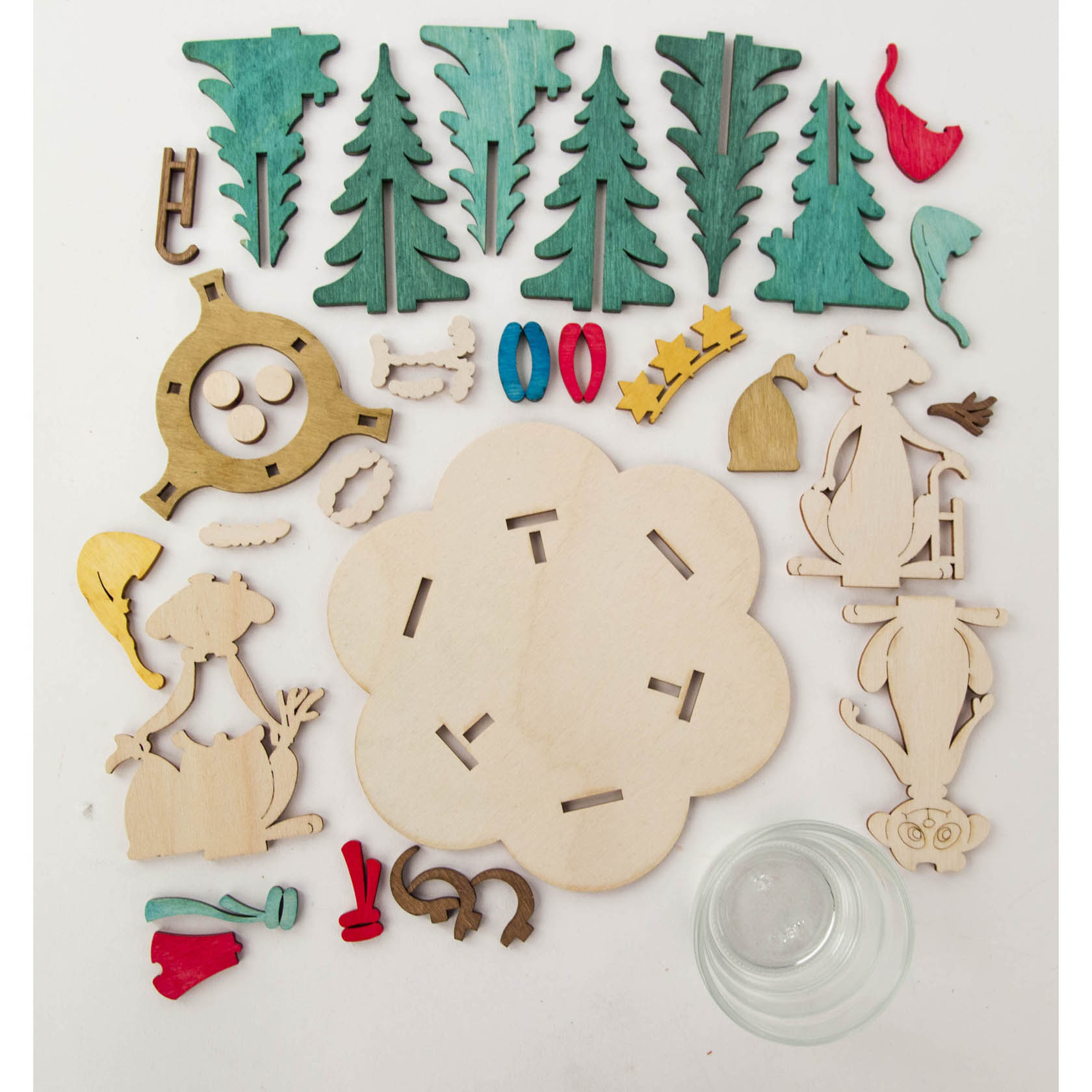 A DIY meerkat tealight holder set with wooden pieces including meerkats, trees, a base, small decorative elements and a glass tealight holder.