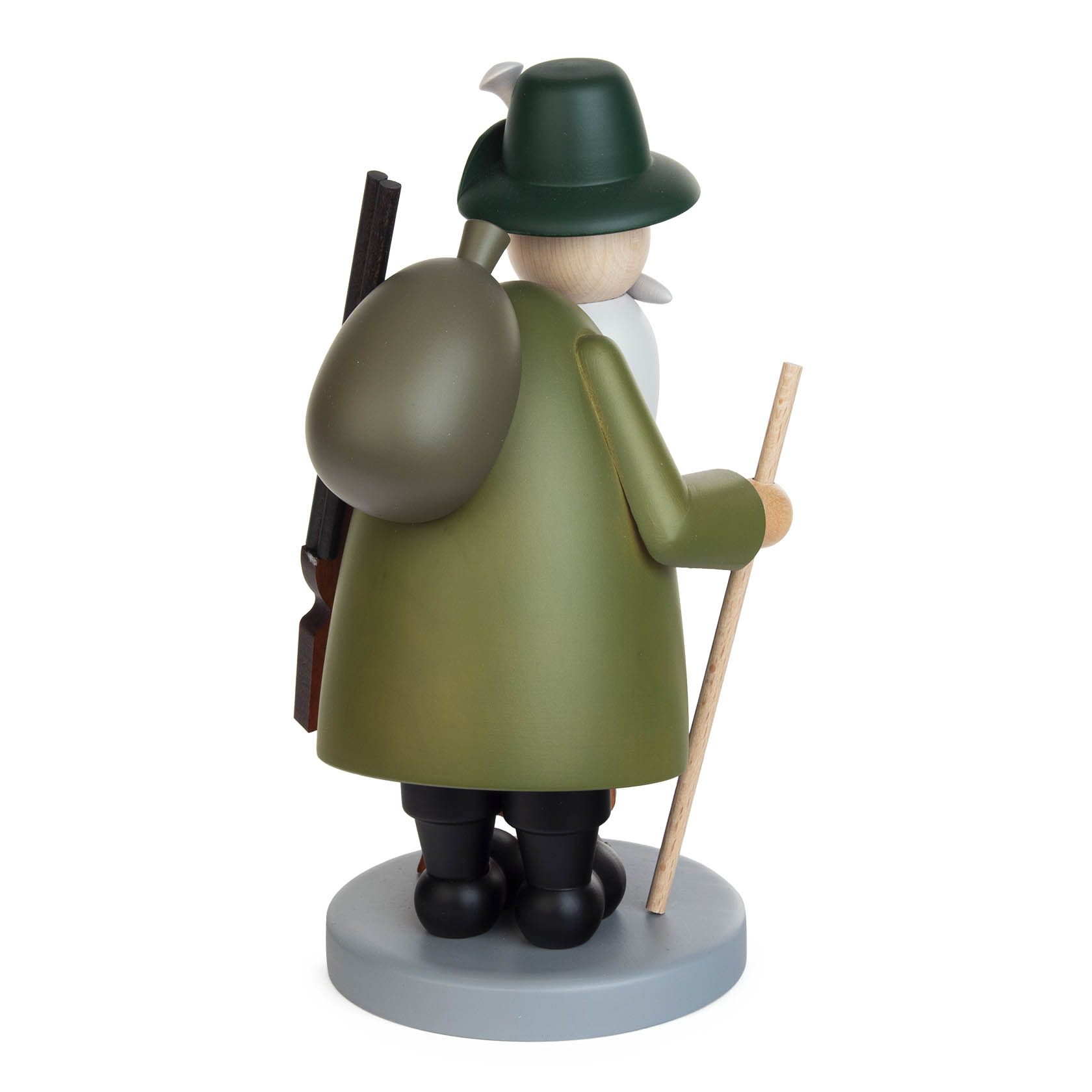 Wooden smoker figure of a forester with a green coat and hat, holding a stick and carrying a rifle and a bag on his back. A small dachshund follows behind.