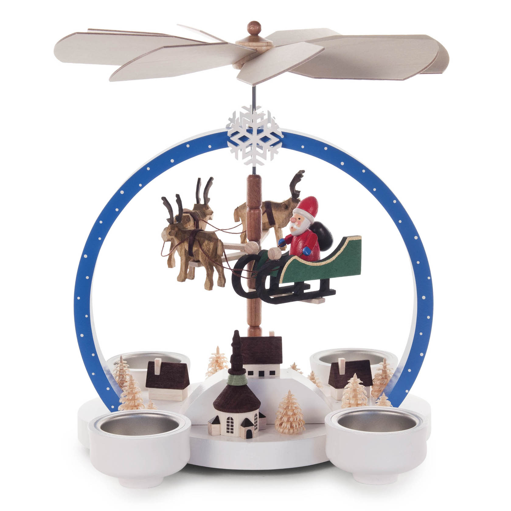 Colorful round winter-themed pyramid with tealight holders, featuring Santa in a sleigh pulled by reindeer, under large wooden fan blades.