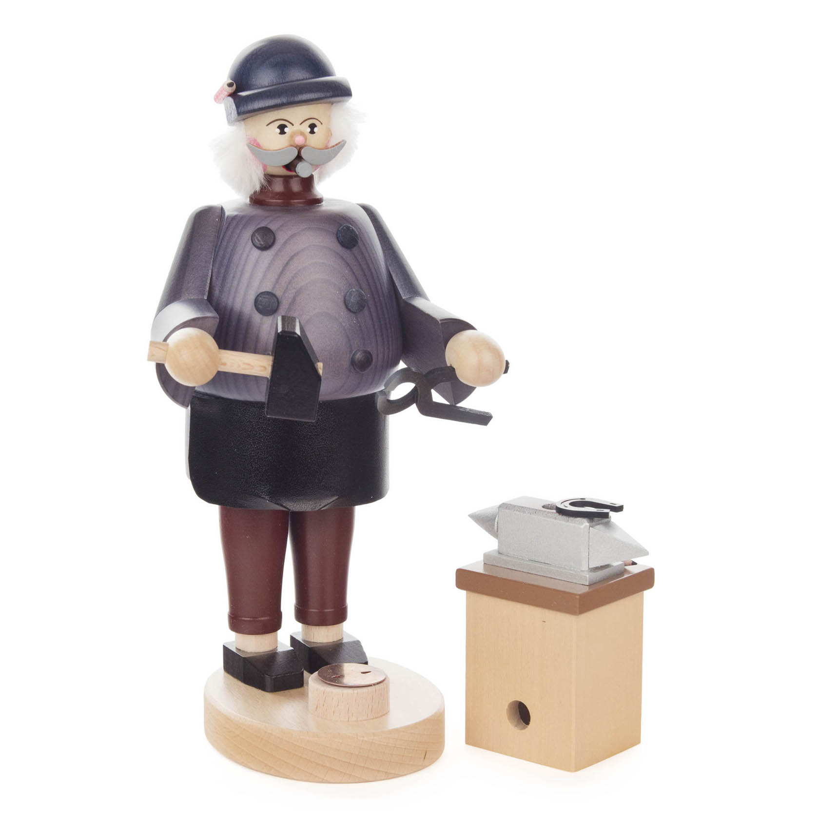 A traditional wooden incense smoker figure of a blacksmith, wearing a helmet and apron, holding a hammer and tongs next to an anvil on a wooden stand.