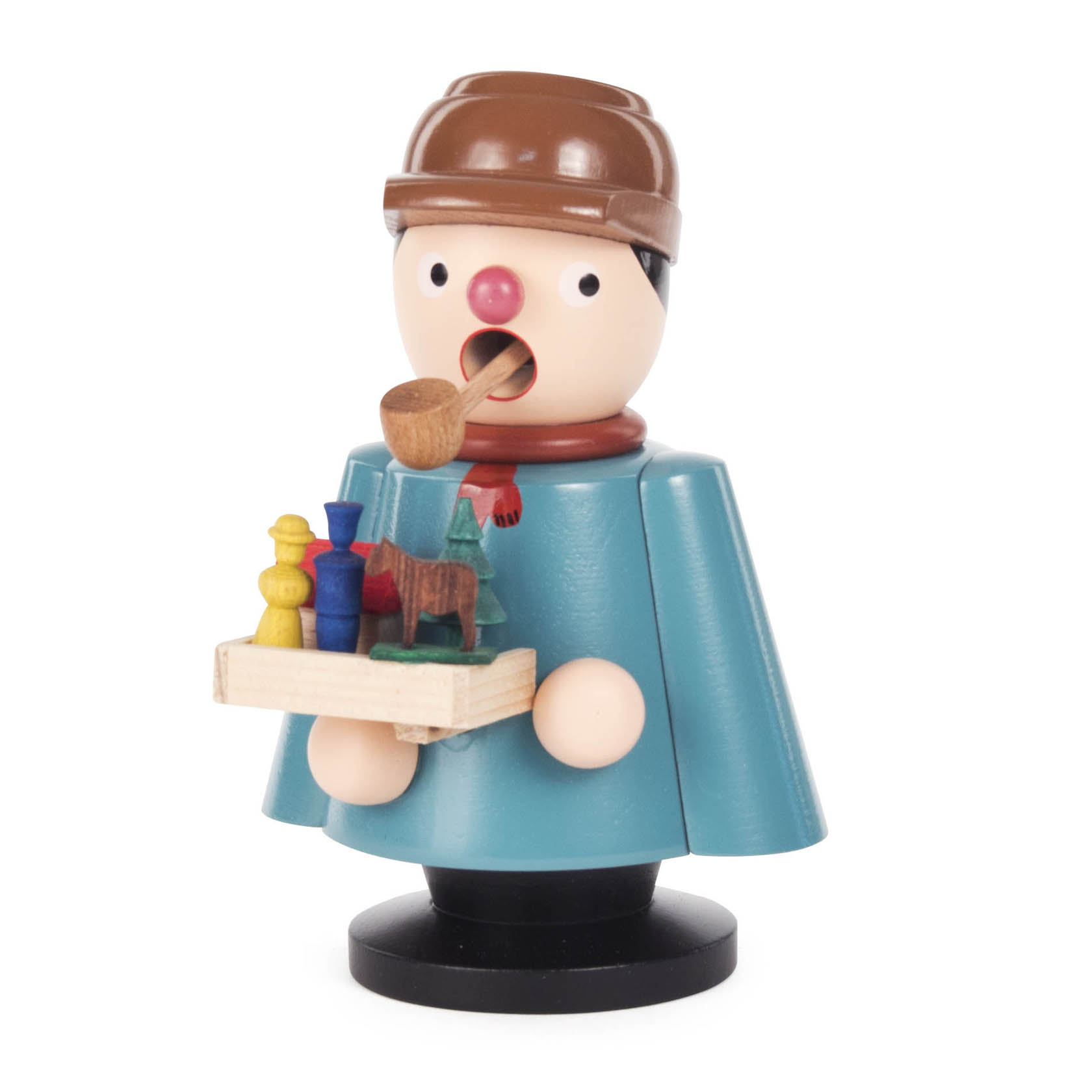 Räuchermann in Form eines Spielzeughändlers mit Pfeife, blauer Jacke und braunem Hut, hält eine Holzplatte mit buntem Spielzeug.