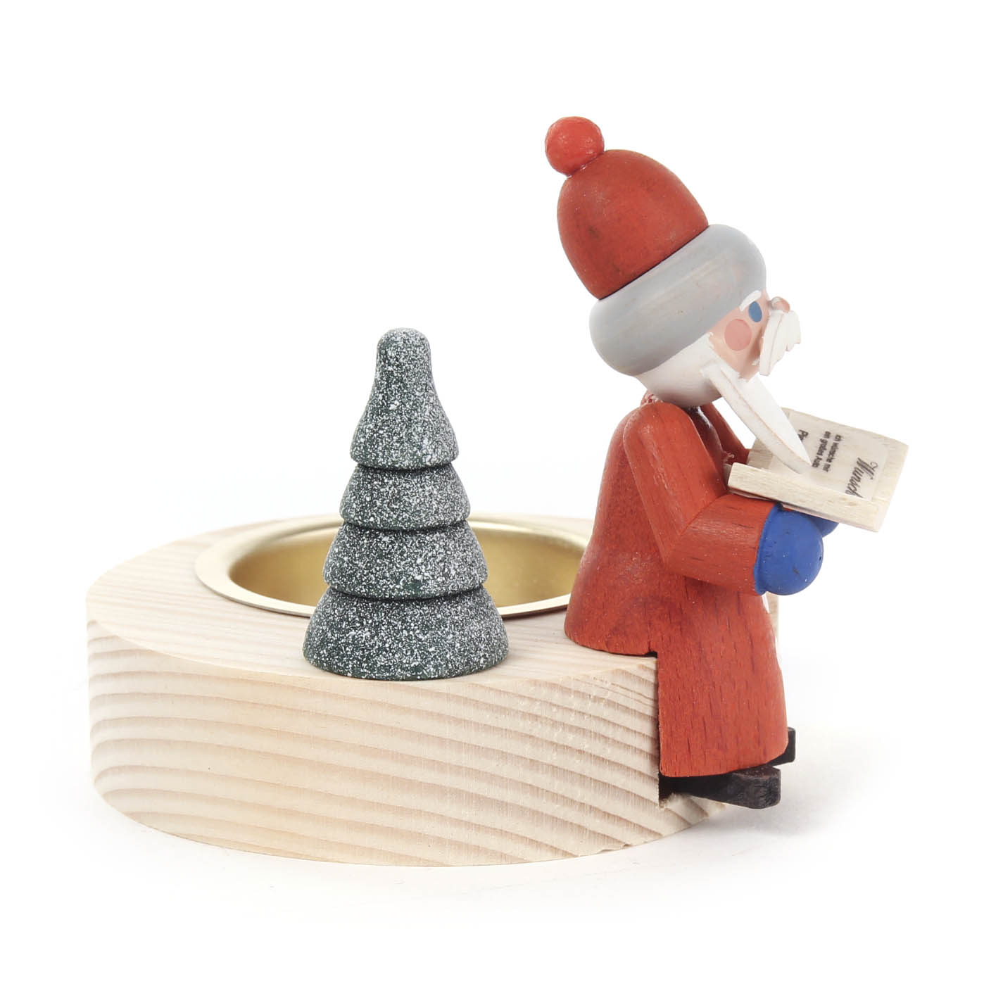 Wooden tealight holder with a Santa figurine sitting and reading a book, next to a small glittering fir tree.
