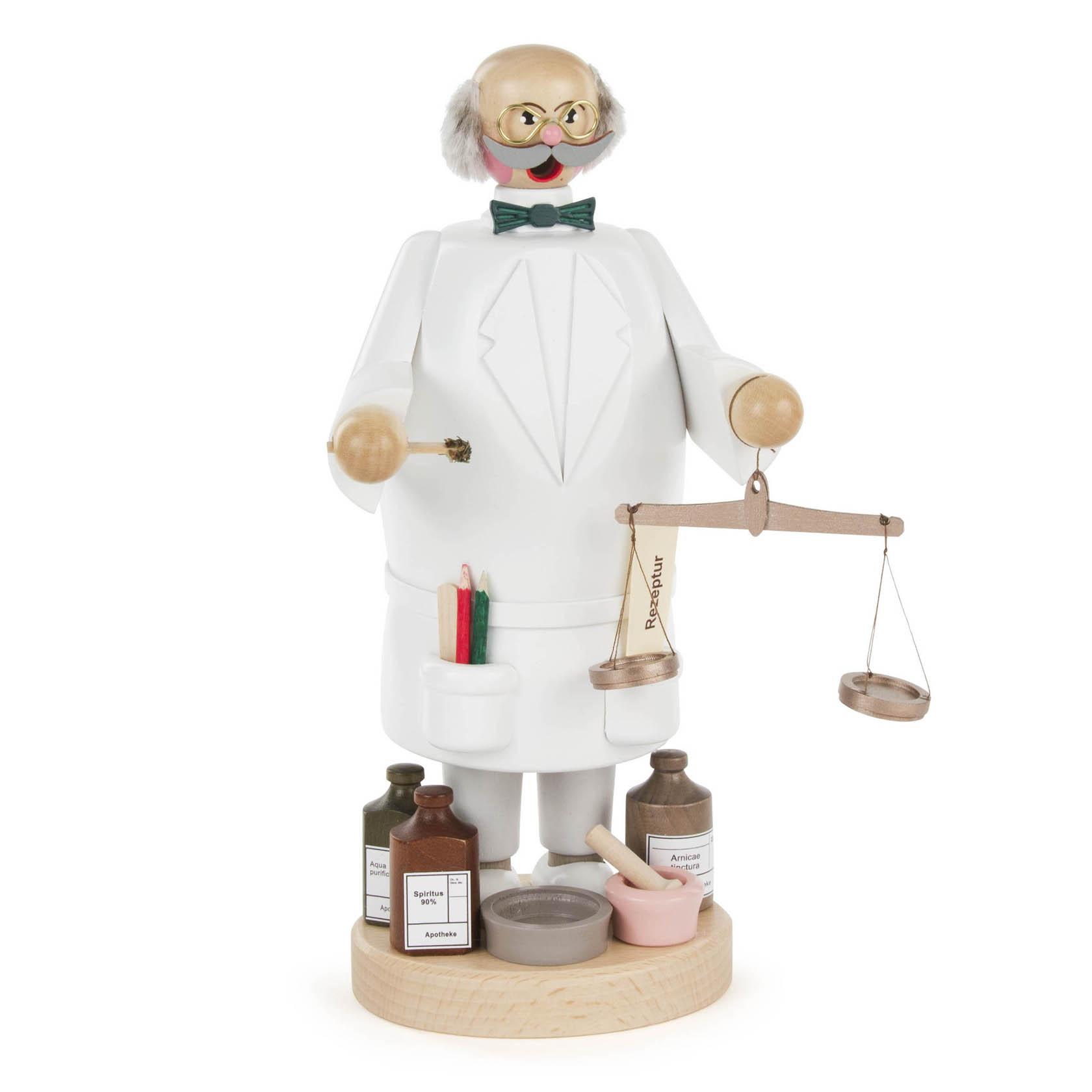 A wooden incense smoker figure of a pharmacist wearing a lab coat, glasses, and bow tie, holding a scale with different colored jars at his feet.