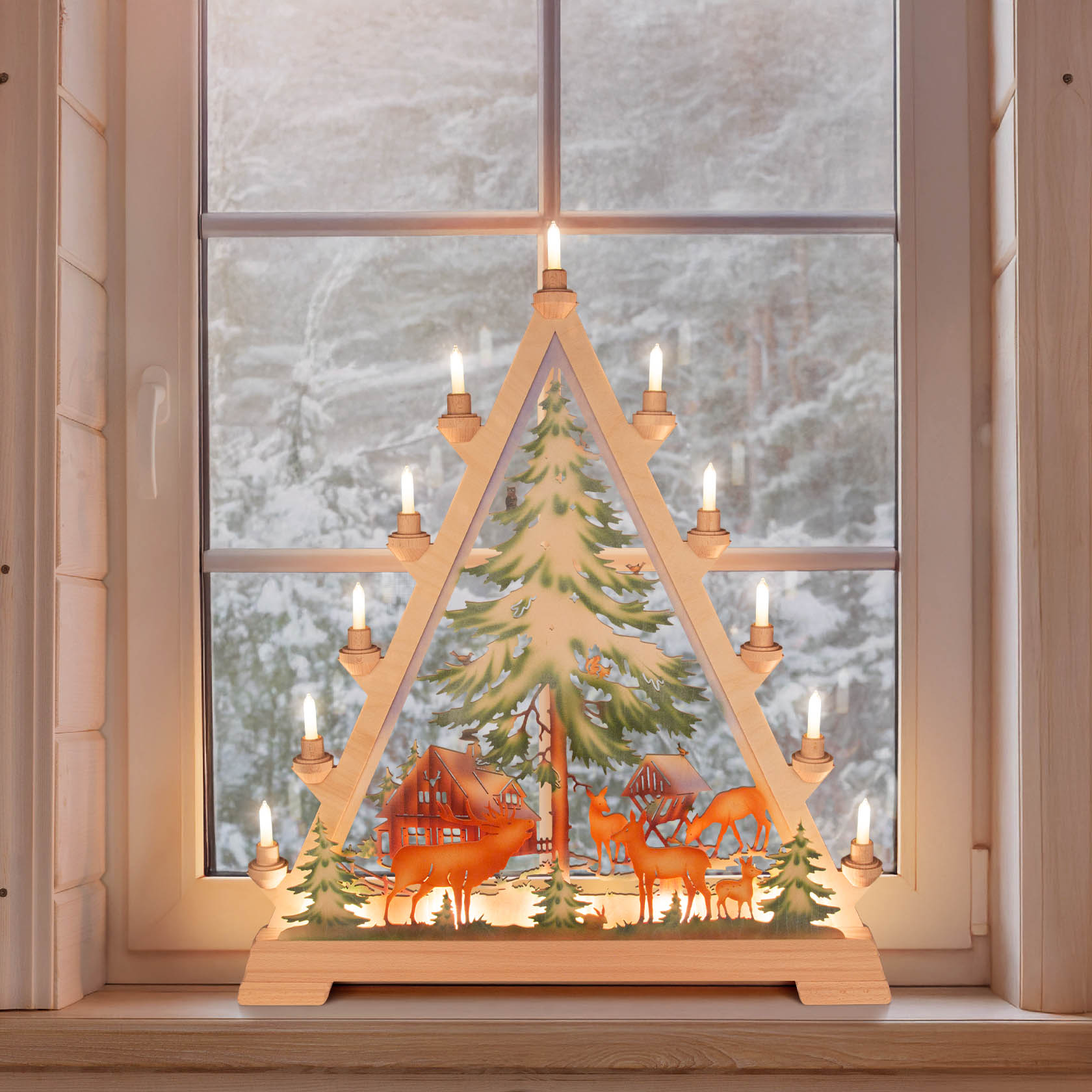 Illuminated triangular arch with a colorful forest scene, featuring a deer, trees, and a rustic house set in a winter landscape.