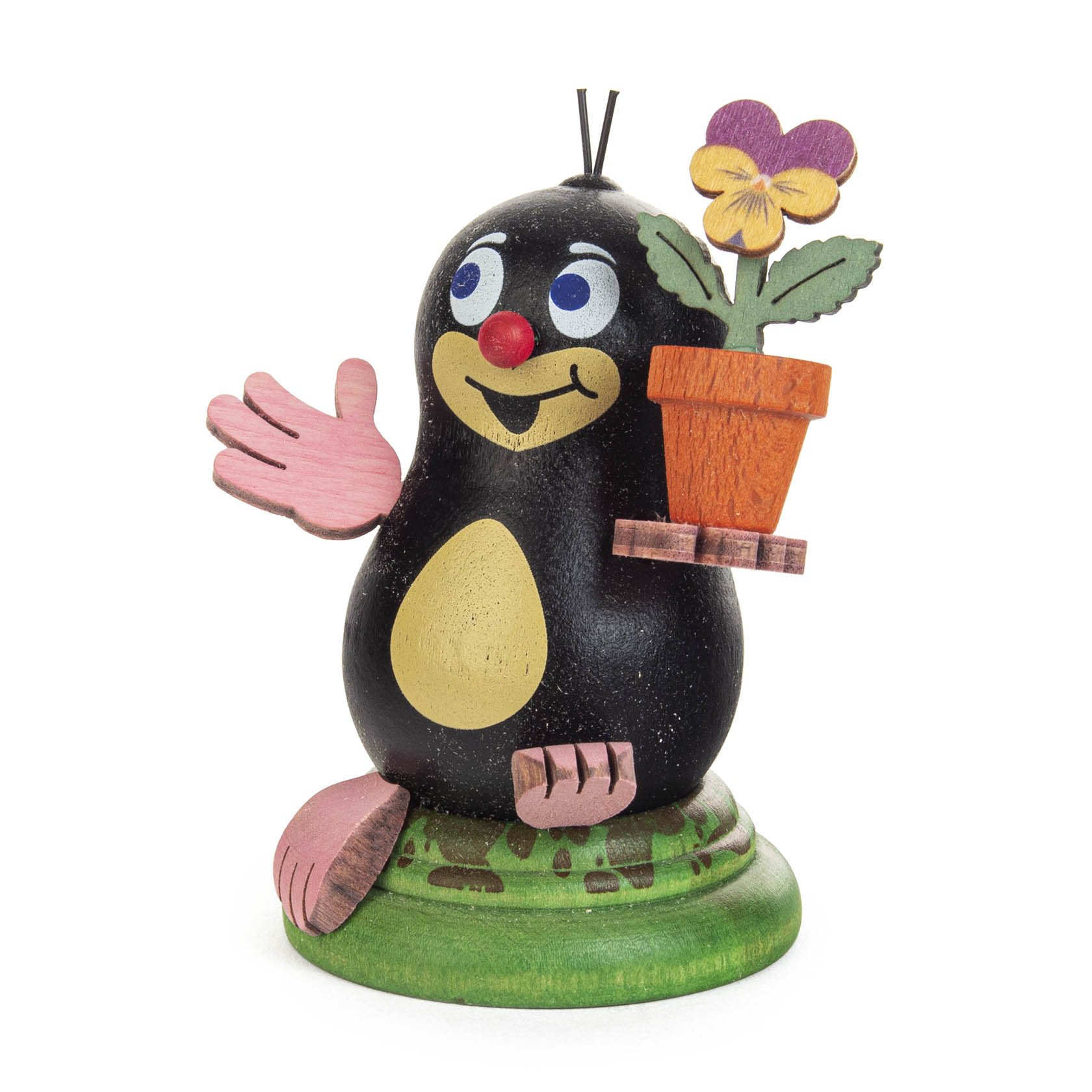 Holzfigur eines schwarz-bunten Maulwurfs mit rosa Händen und Füßen, lächelnd, haltend einen Blumentopf mit gelber Blume. im Dregeno Online Shop günstig kaufen