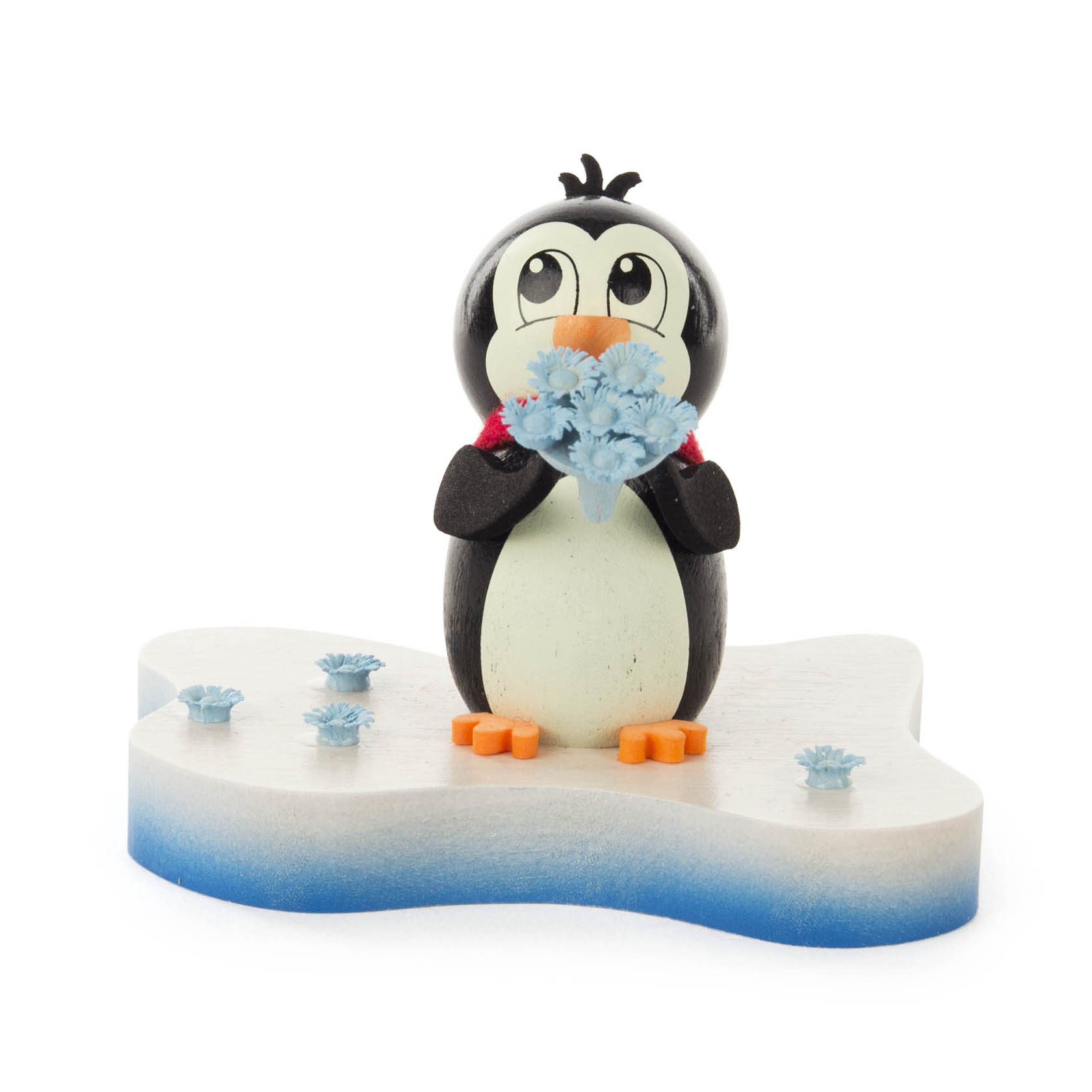 A cute penguin figurine holding a bouquet of light blue flowers stands on an ice-shaped base, with additional flowers scattered around its feet.