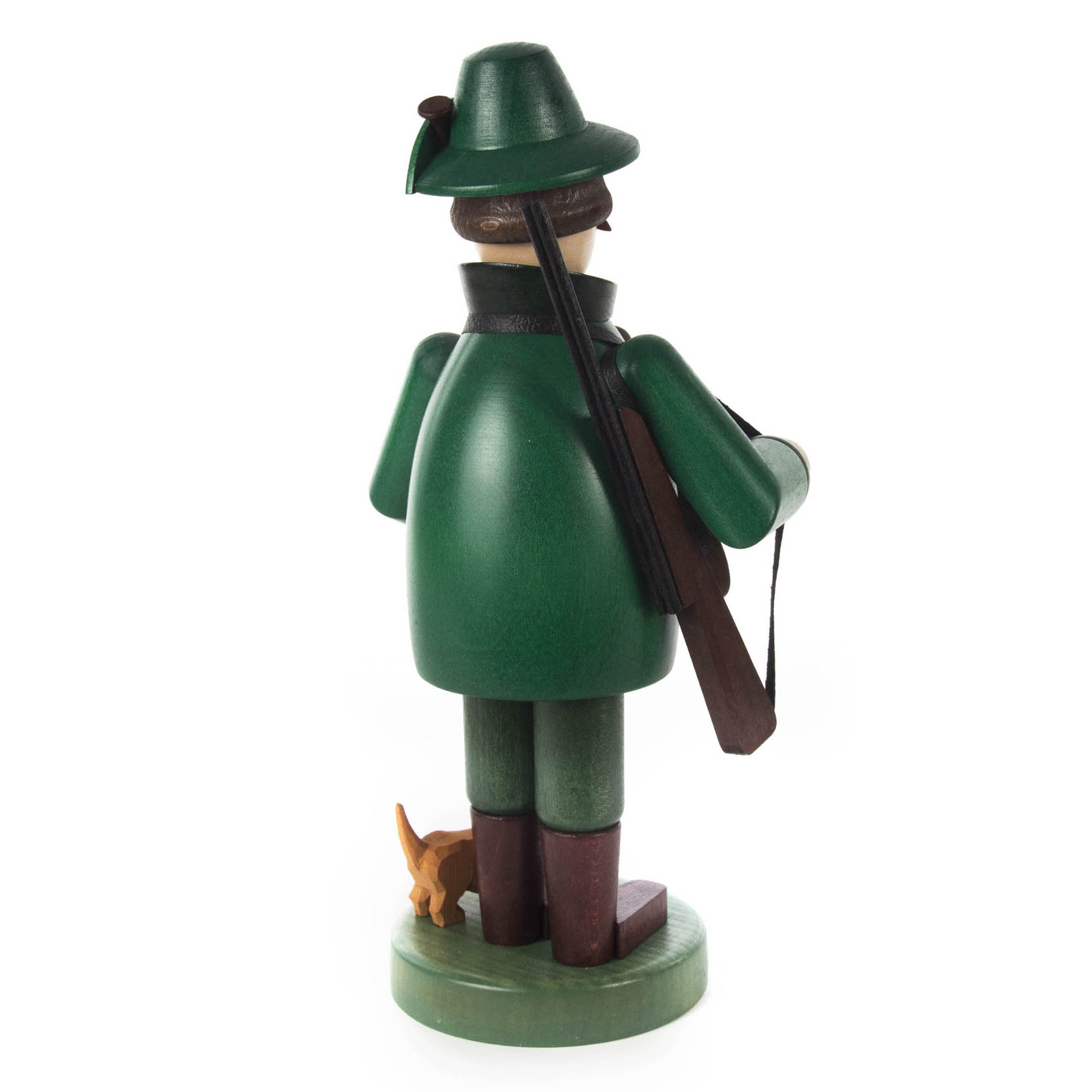 A wooden incense smoker figure of a forester wearing a green coat and hat, holding a rifle, with a small dog standing beside him.
