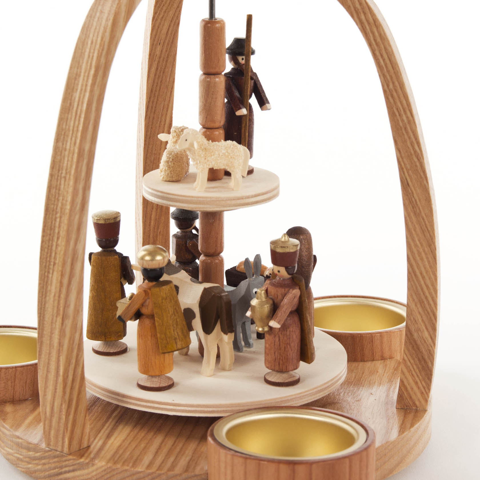 Wooden nativity pyramid with tea light holders, featuring handcrafted figurines including the Three Wise Men, Joseph, Mary, and animals.