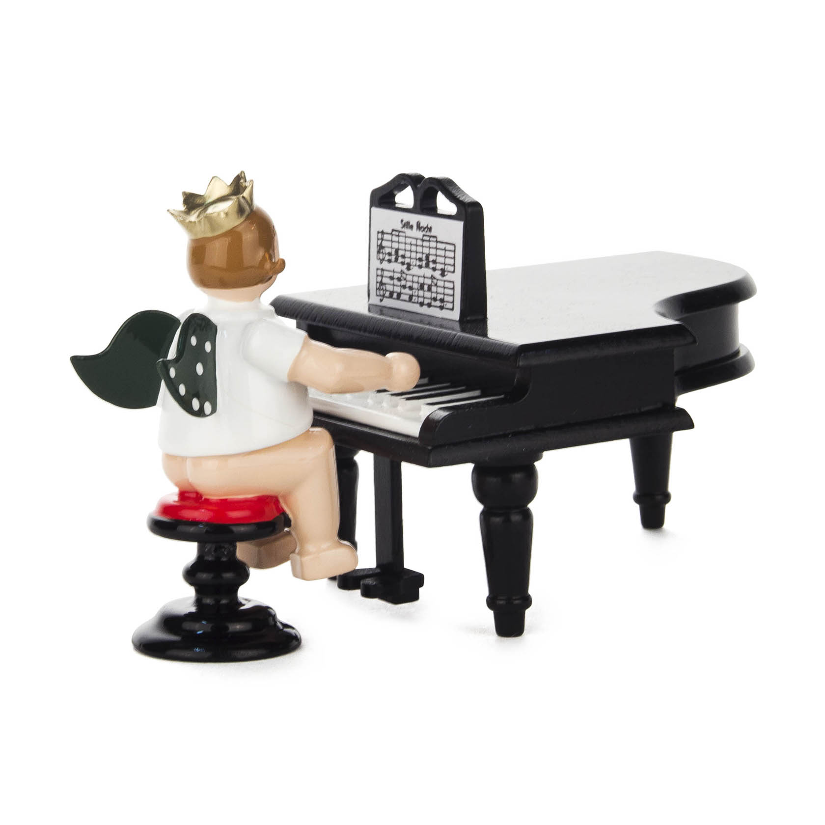 A porcelain figurine of an angel with green wings and a crown, seated on a stool, playing a black grand piano. im Dregeno Online Shop günstig kaufen