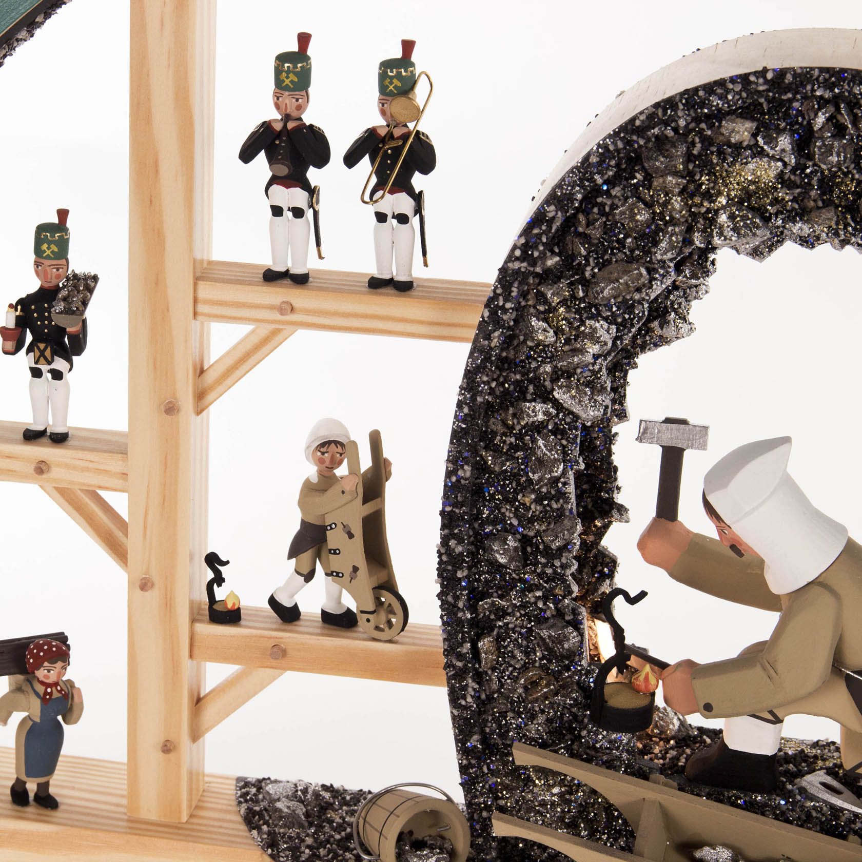 Wooden arch with figures from the Ore Mountains, including a miner in traditional attire and musicians, illuminated with electric lights.