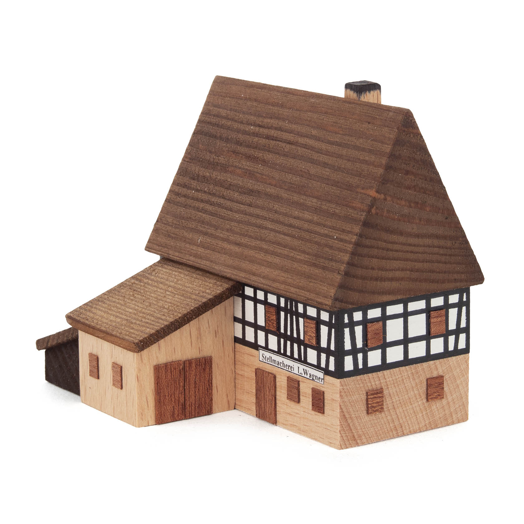 A two-story traditional German half-timbered structure representing a wheelwright's shop with an adjacent workshop extension.