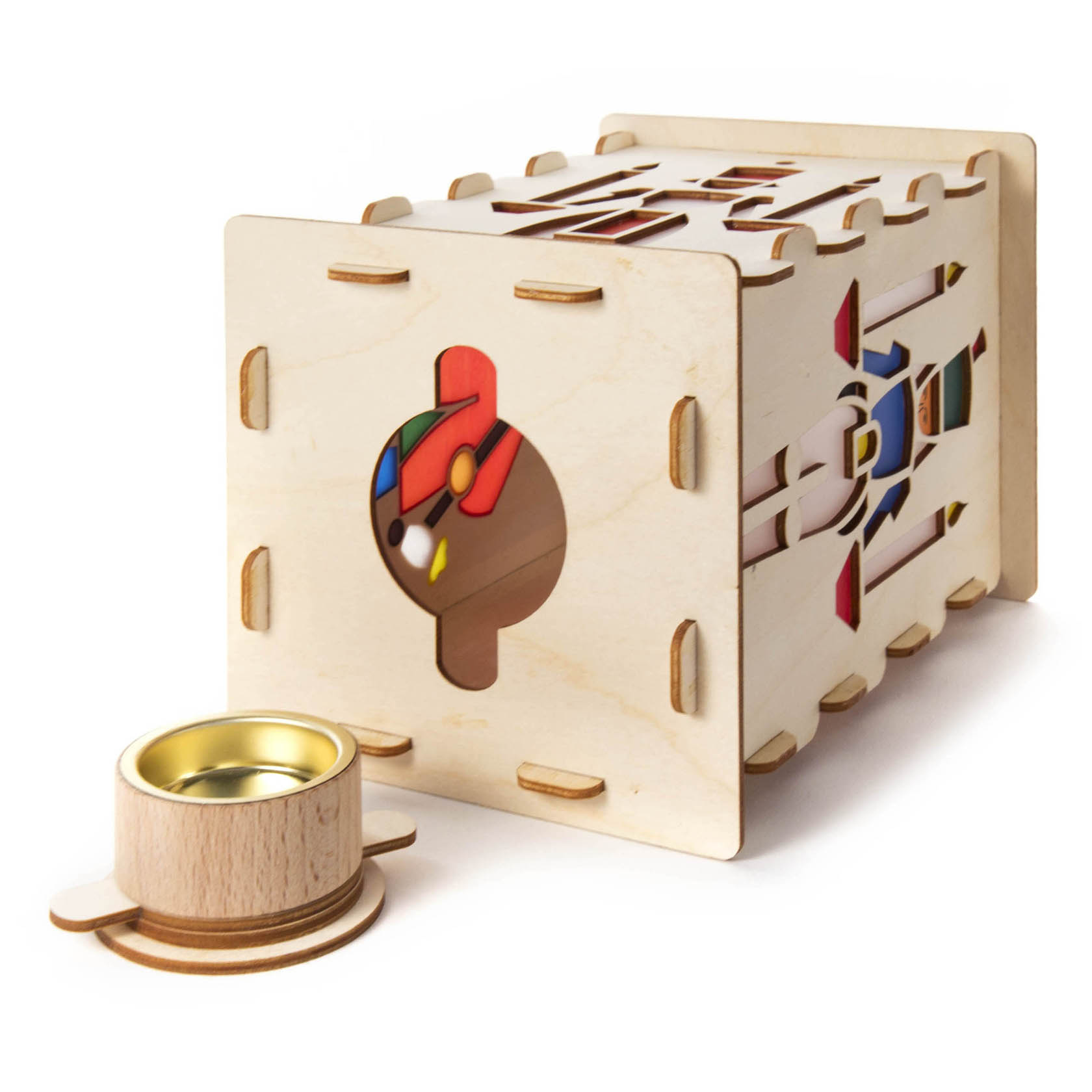 A wooden DIY table lantern set featuring a rectangular frame with colorful geometric cutouts and a detachable tealight holder.