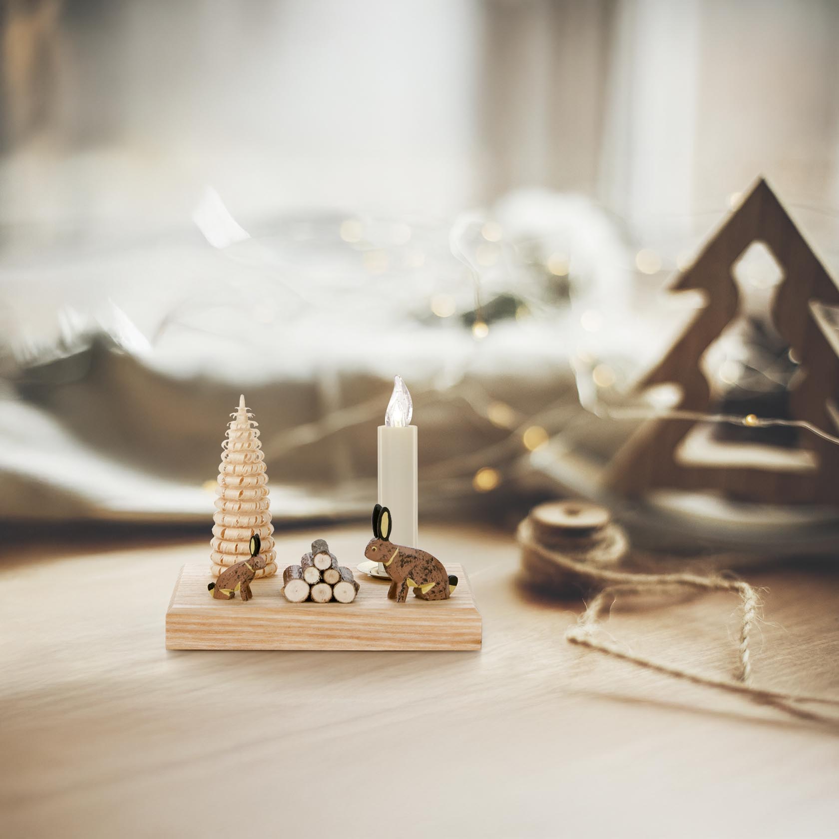 Wooden candle holder featuring two rabbit figurines, a spiral-shaped wooden tree, and a small stack of wood logs, designed for a 14mm candle.
