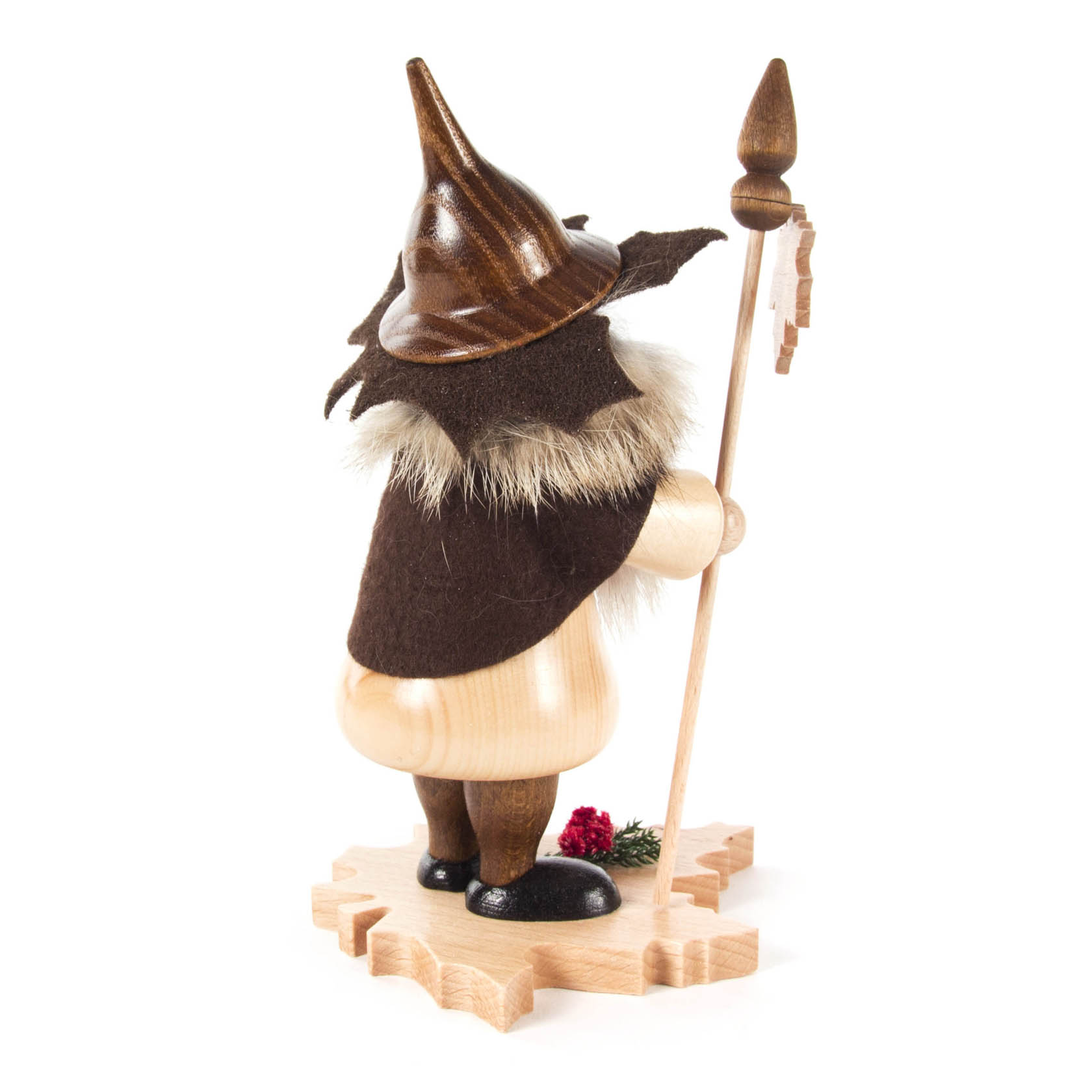 Wooden incense smoker shaped as a tree gnome with a brown hat, cloak, and staff, standing on a maple leaf base, with a small red decoration near the feet.